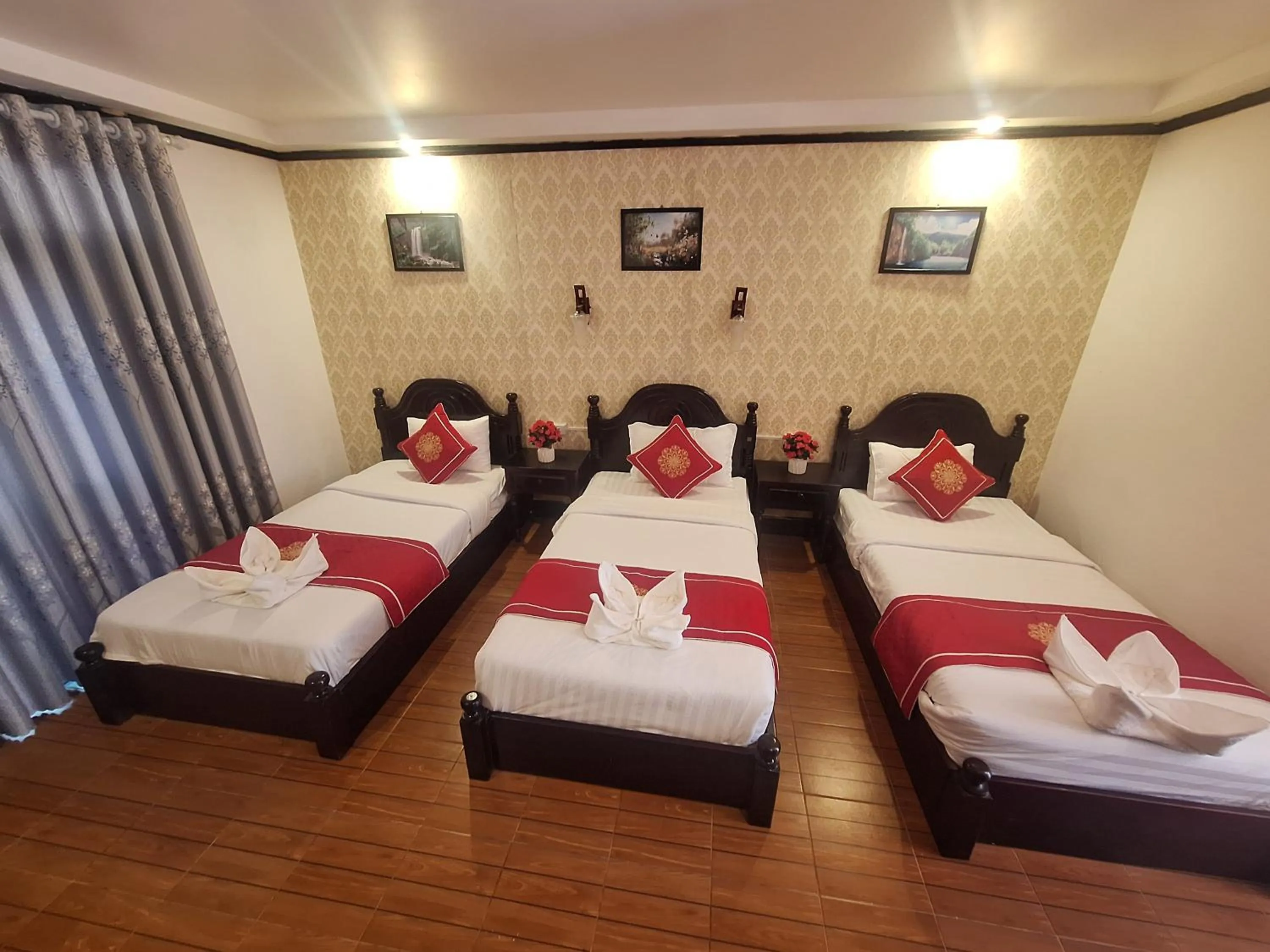 Bed in Luang Prabang Pavilion Hotel & Travel