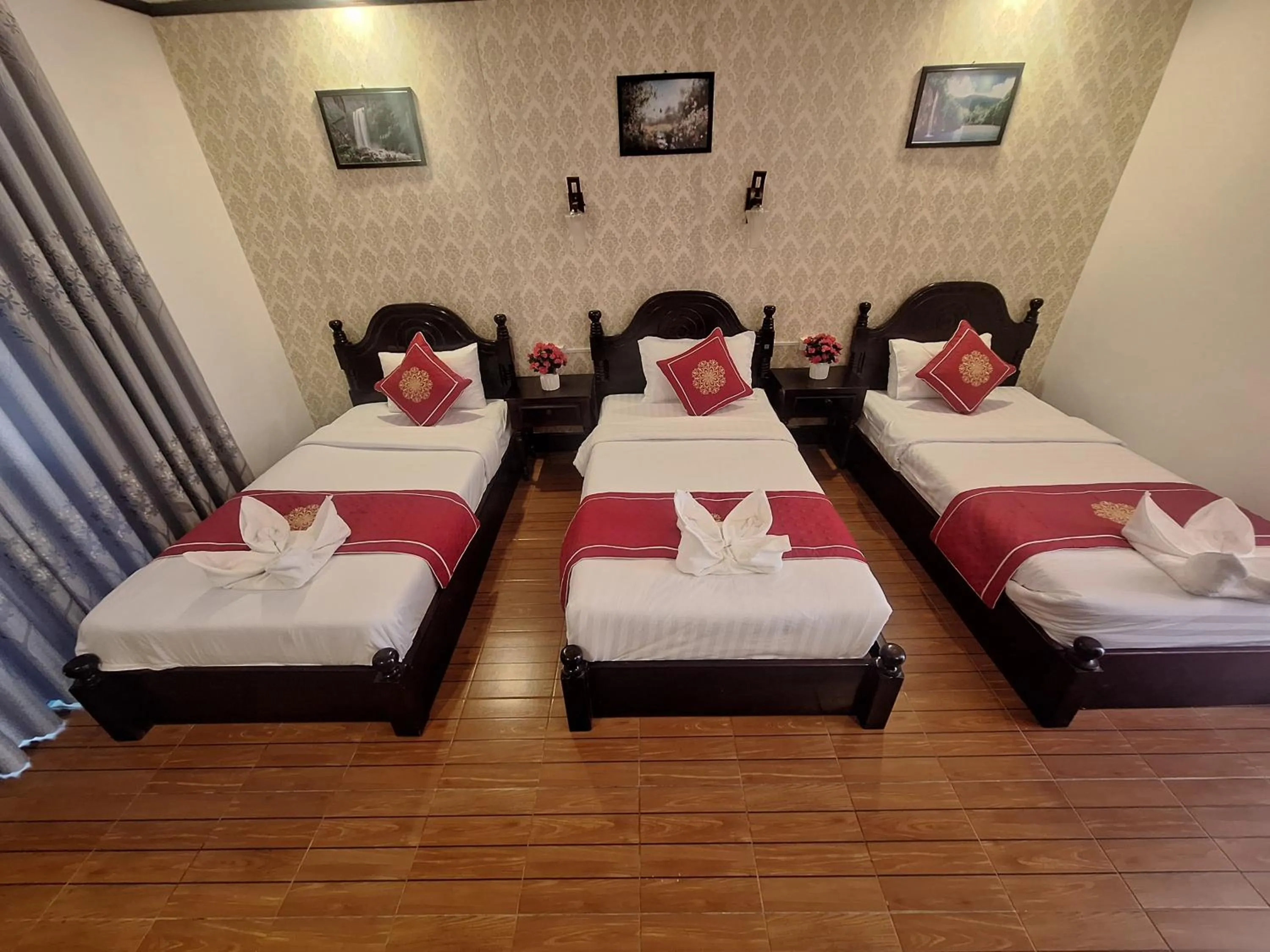 Bed in Luang Prabang Pavilion Hotel & Travel