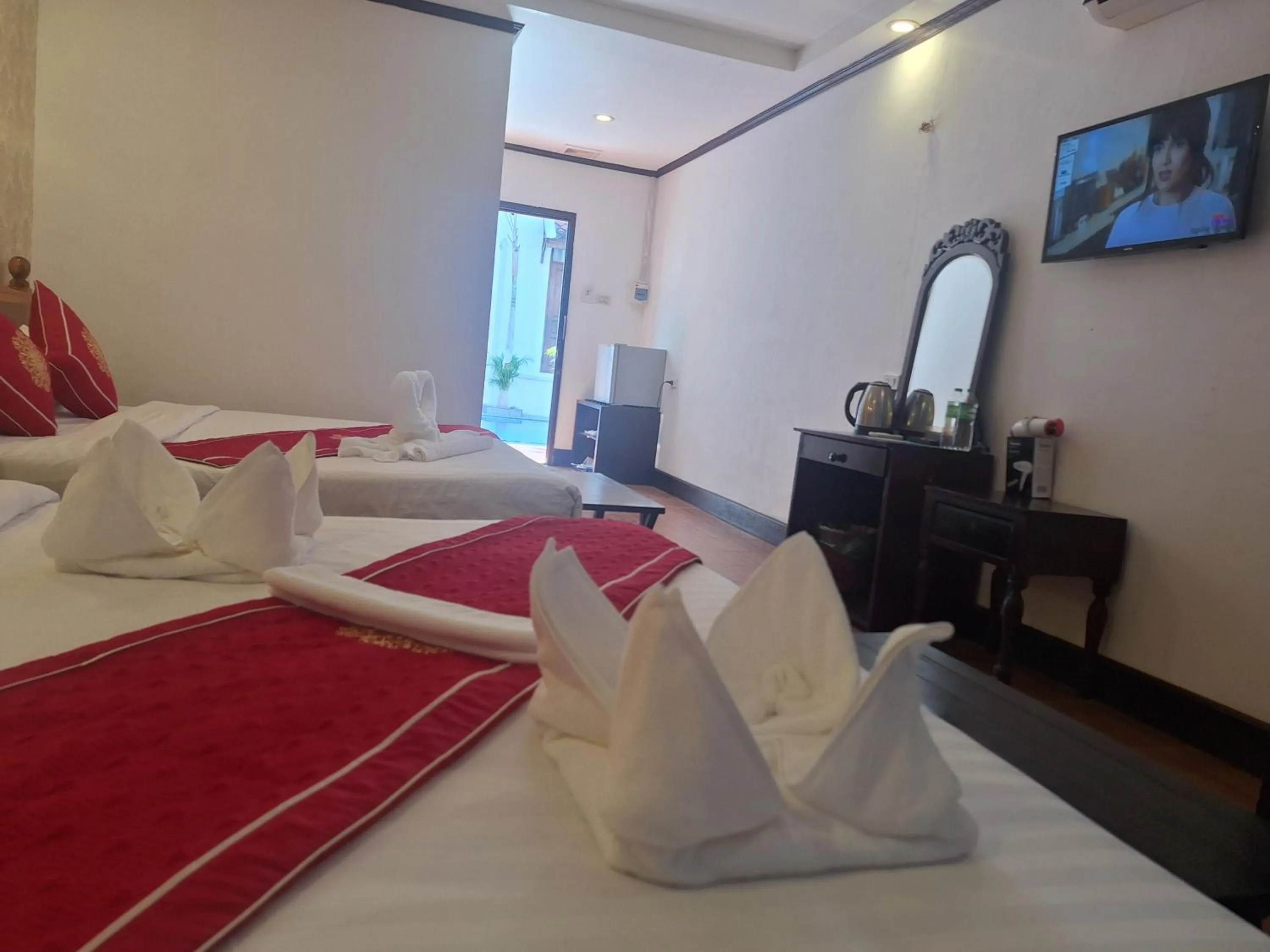 Bed in Luang Prabang Pavilion Hotel & Travel