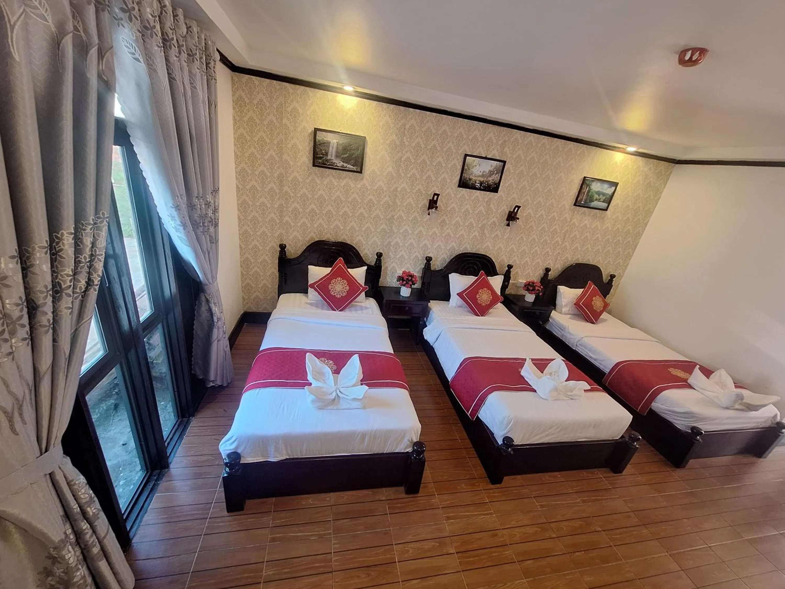 Bed in Luang Prabang Pavilion Hotel & Travel