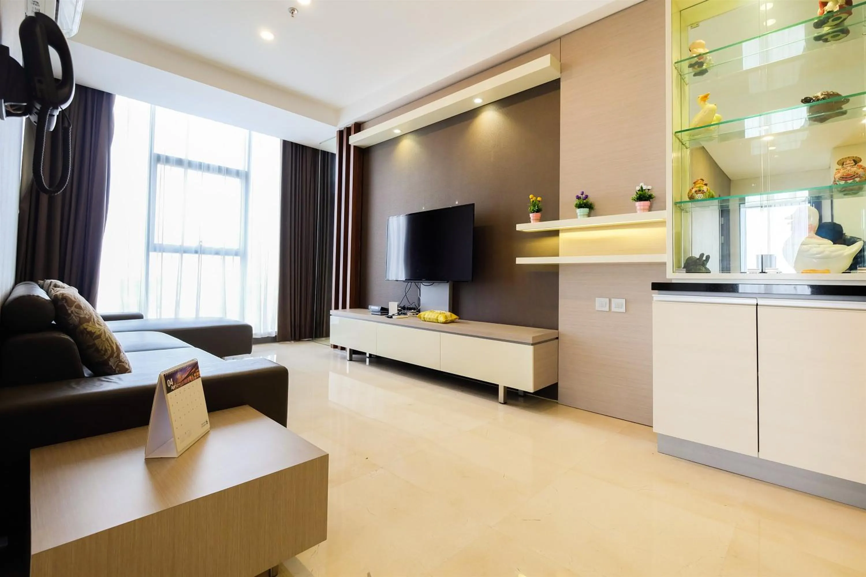 TV and multimedia in Modern Elegant Design 2BR L'Avenue Apartment By Travelio