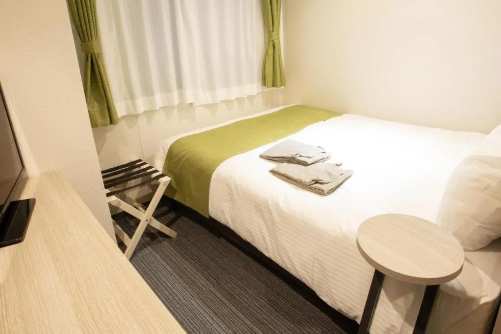 Bed in Kuretake Inn Osaka Midousuji Hommachi