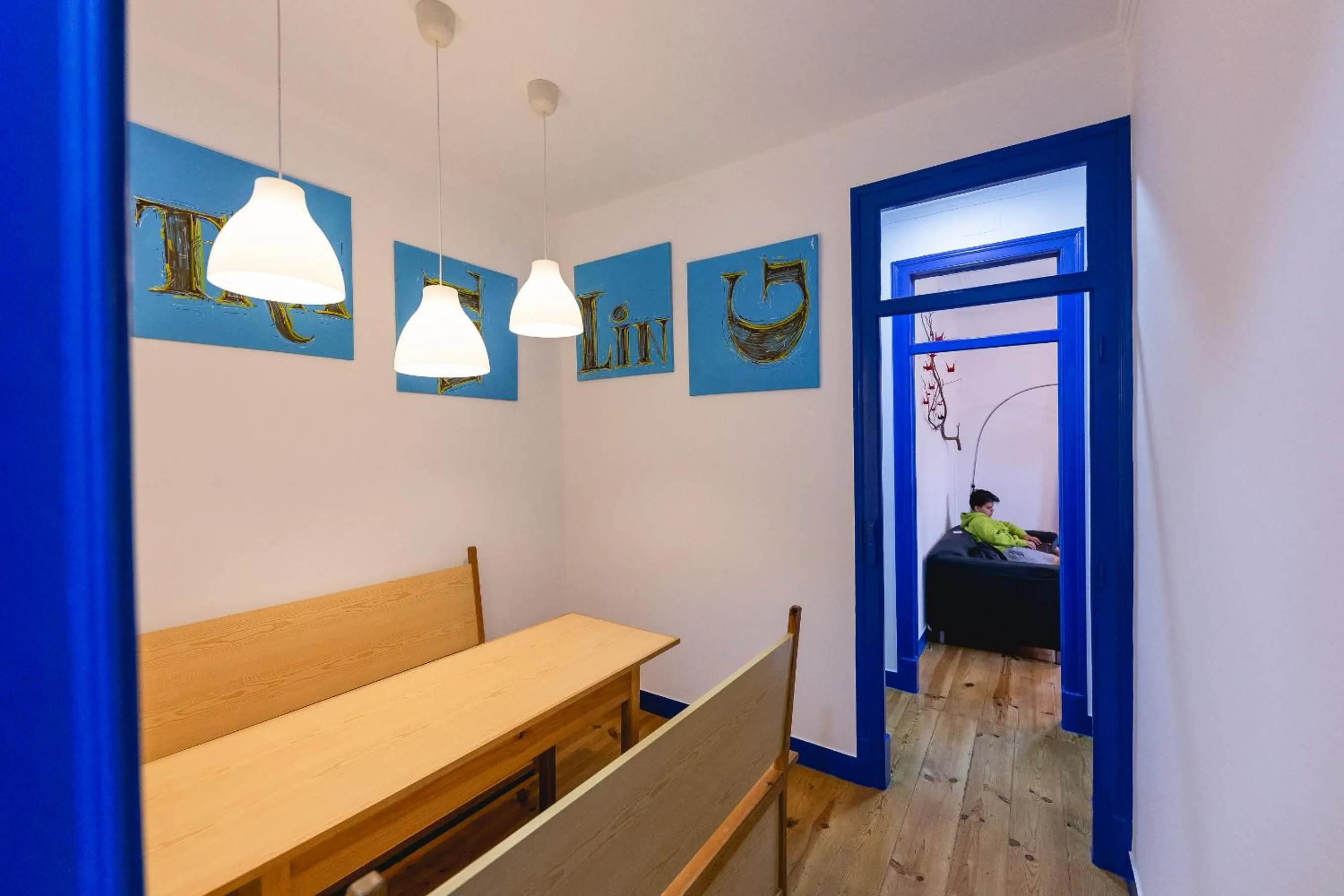 Communal lounge/ TV room, Bed in Help Yourself Hostels - Parede