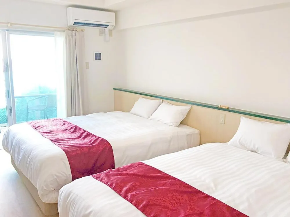 Bed in Hotel Sakurano Familia Nago