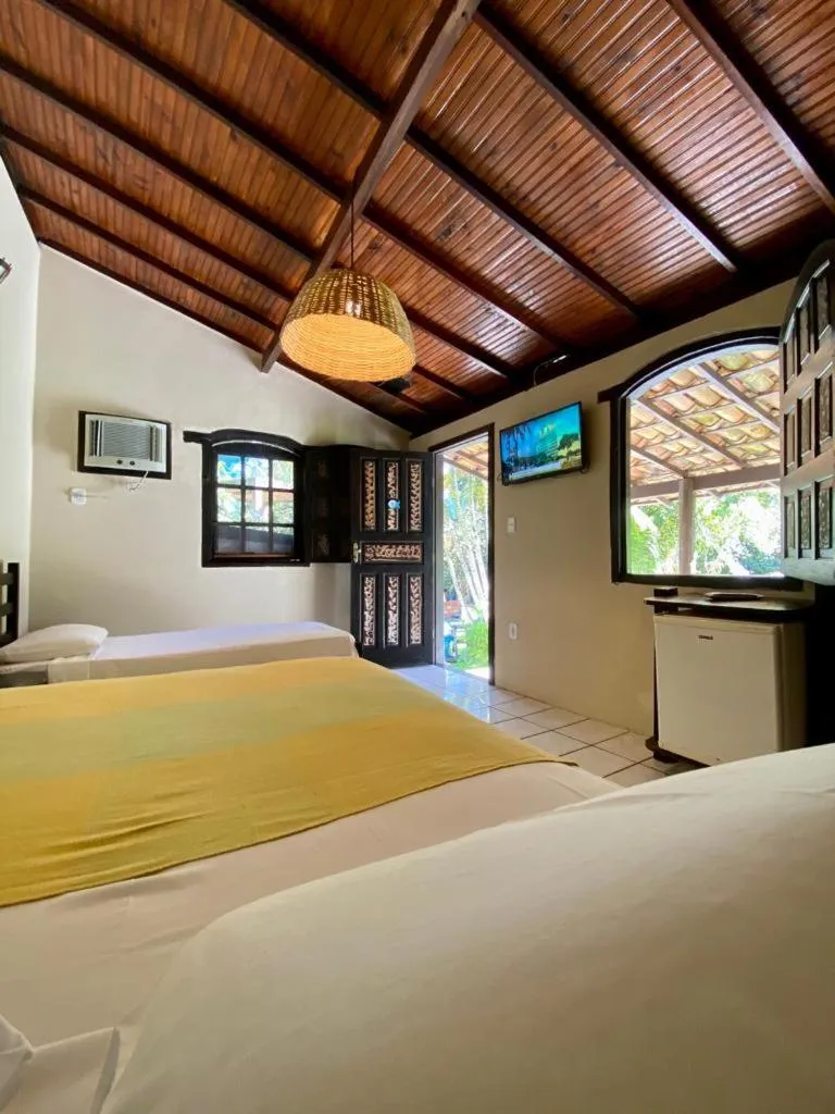 Bed in Pousada Tubarão