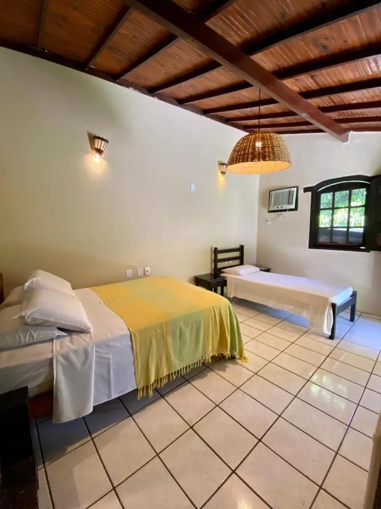 Bed in Pousada Tubarão