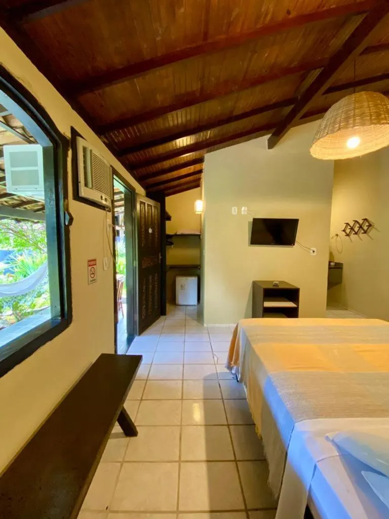 Bed in Pousada Tubarão