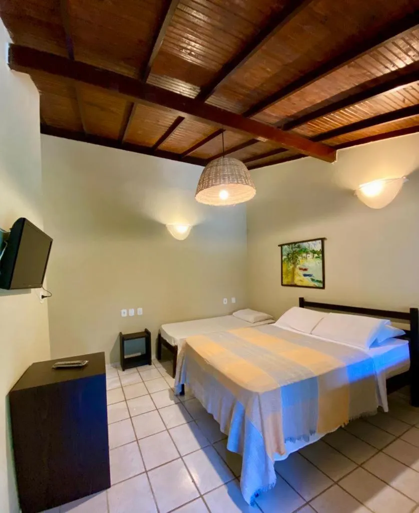 Bed in Pousada Tubarão