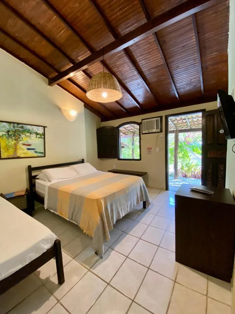 Bed in Pousada Tubarão