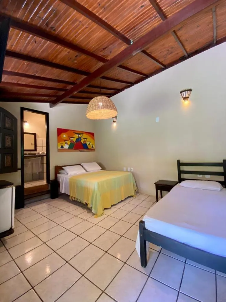Bed in Pousada Tubarão