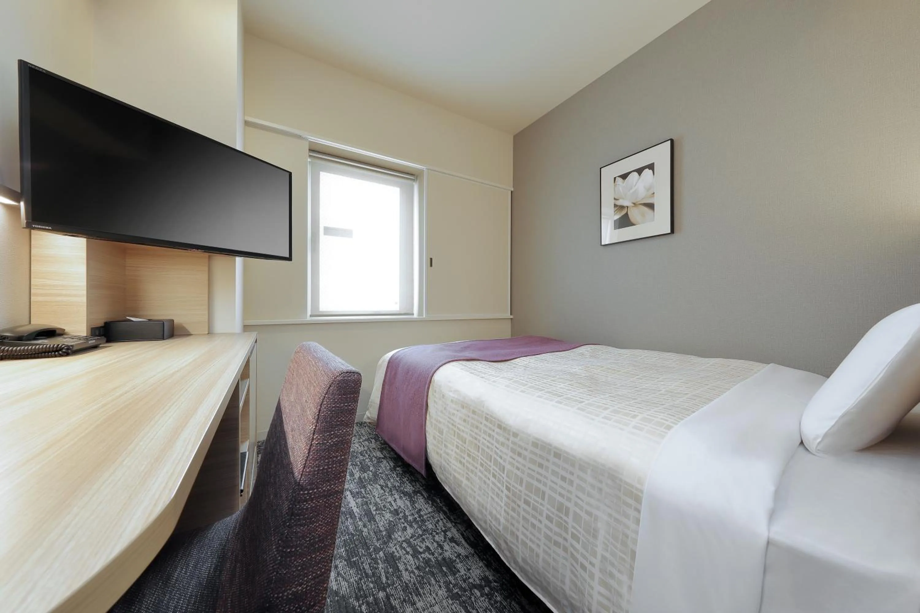 Bed in Keio Presso Inn Tokyo Kudanshita