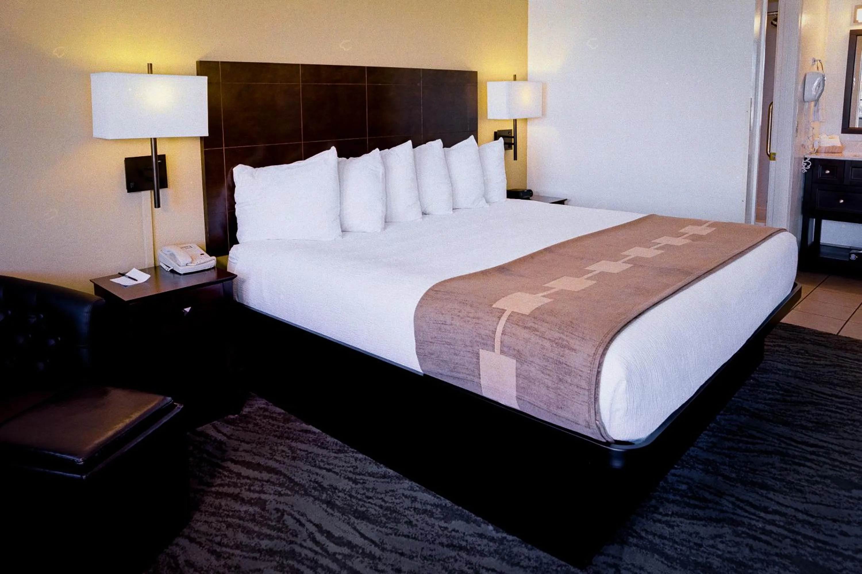 Bed in Pines Inn & Suites