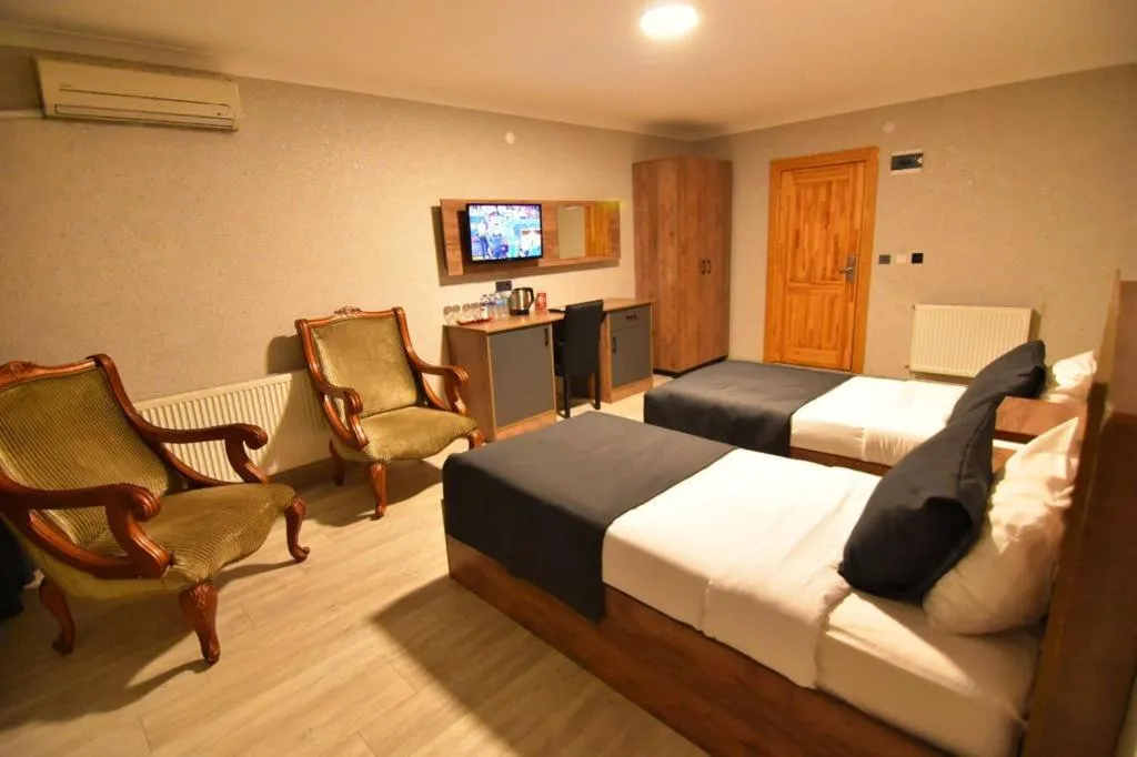 Bed in Green Palace Suite Hotel