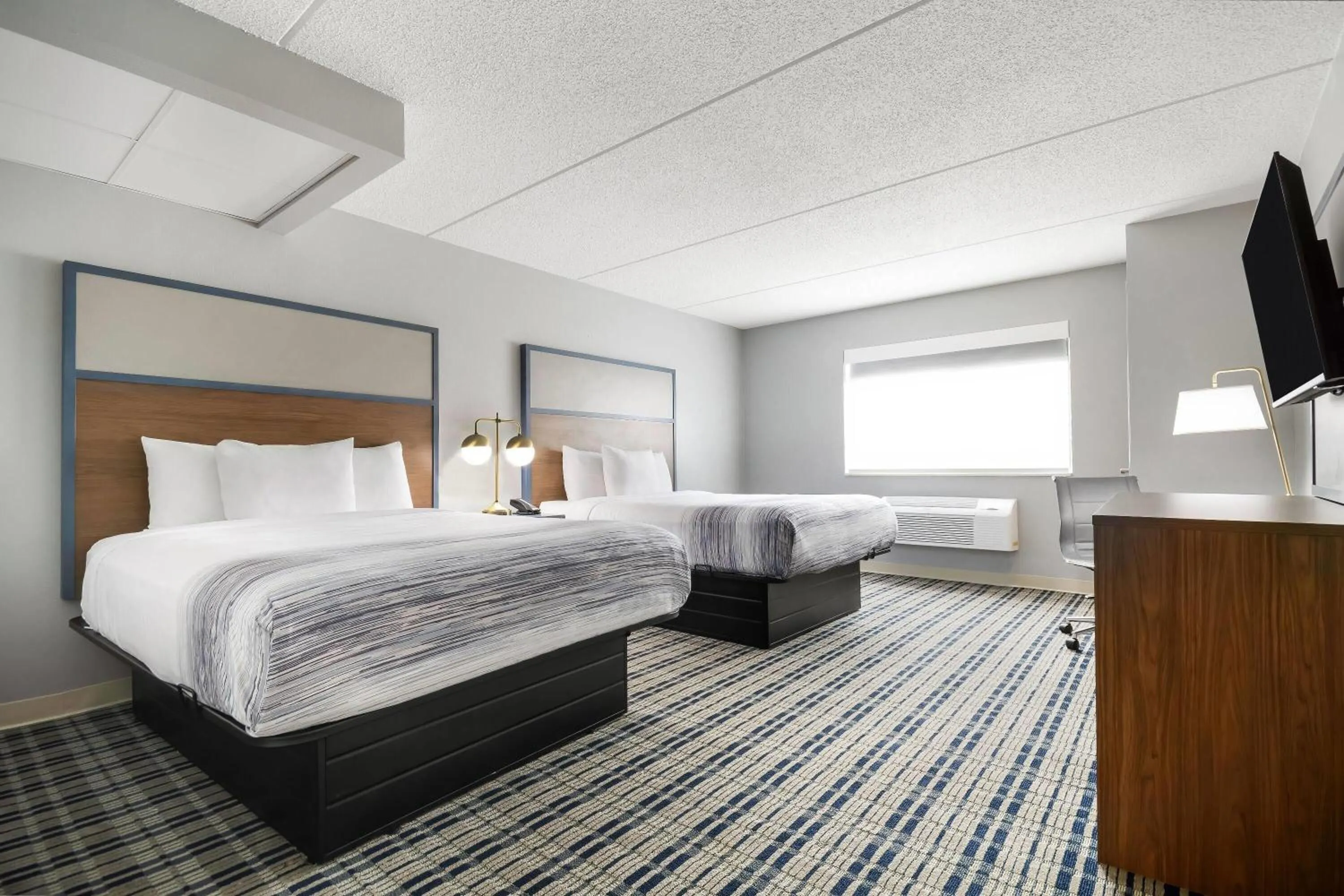 Bed in AmericInn by Wyndham Wausau