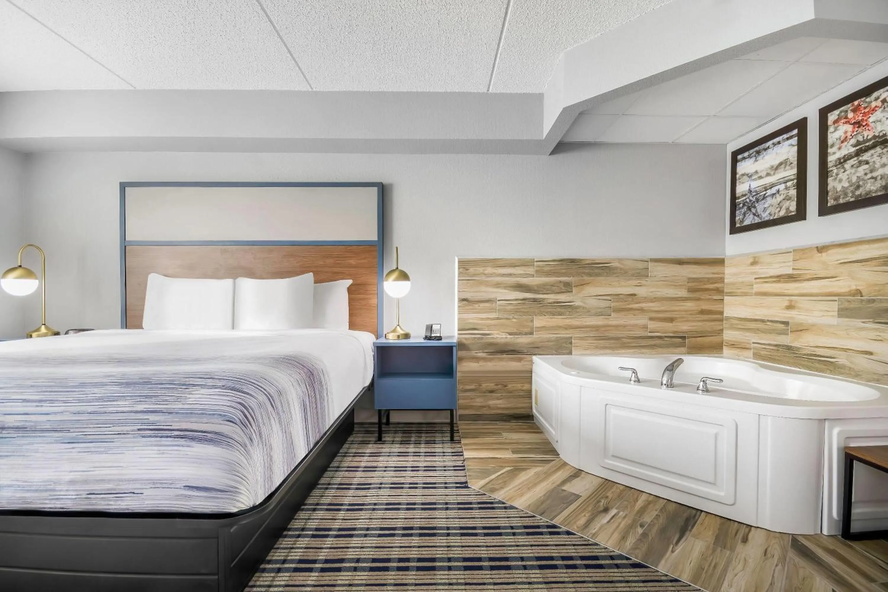 Bed in AmericInn by Wyndham Wausau