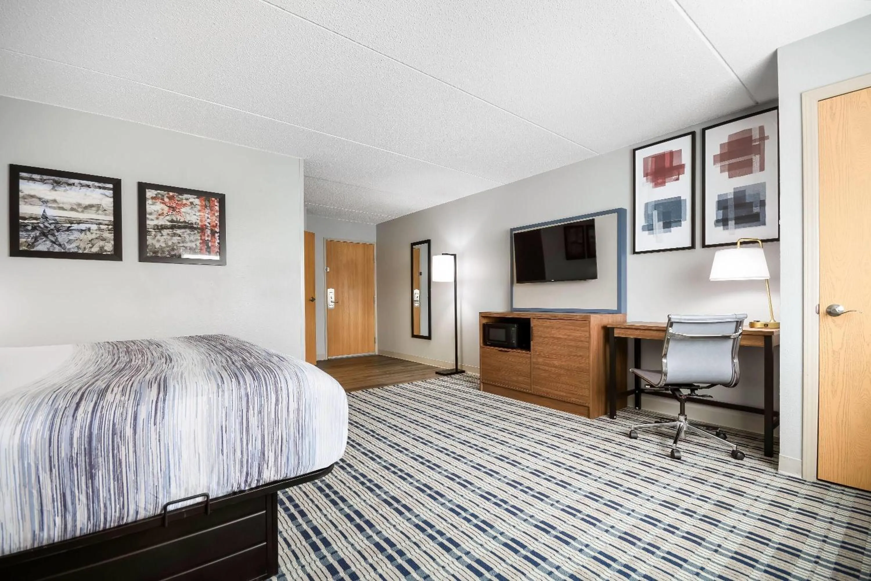 Bed in AmericInn by Wyndham Wausau