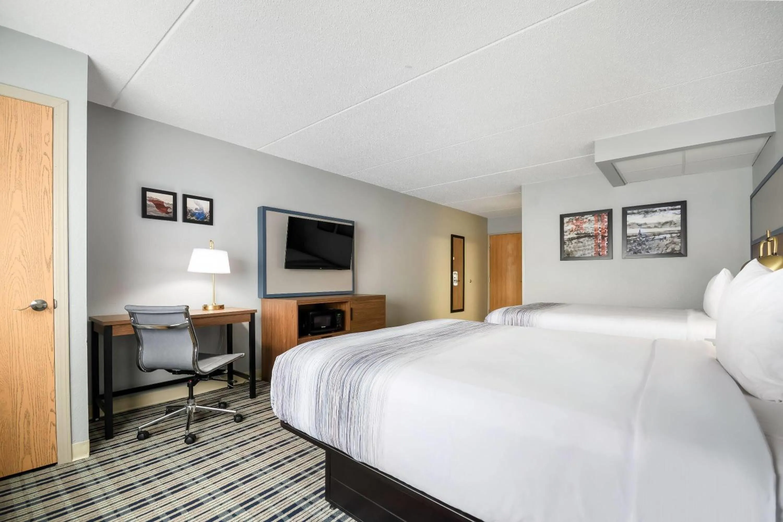 Bed in AmericInn by Wyndham Wausau