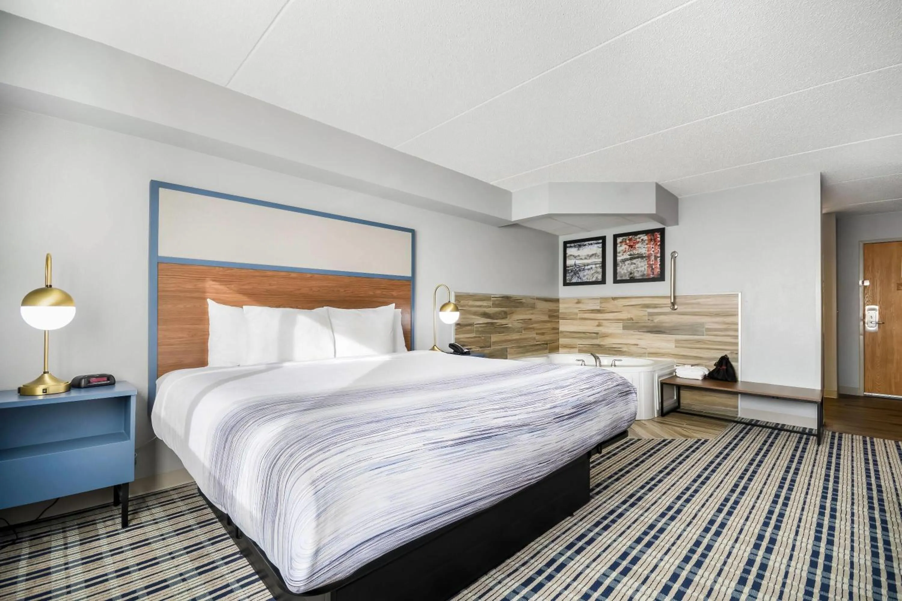 Bed in AmericInn by Wyndham Wausau