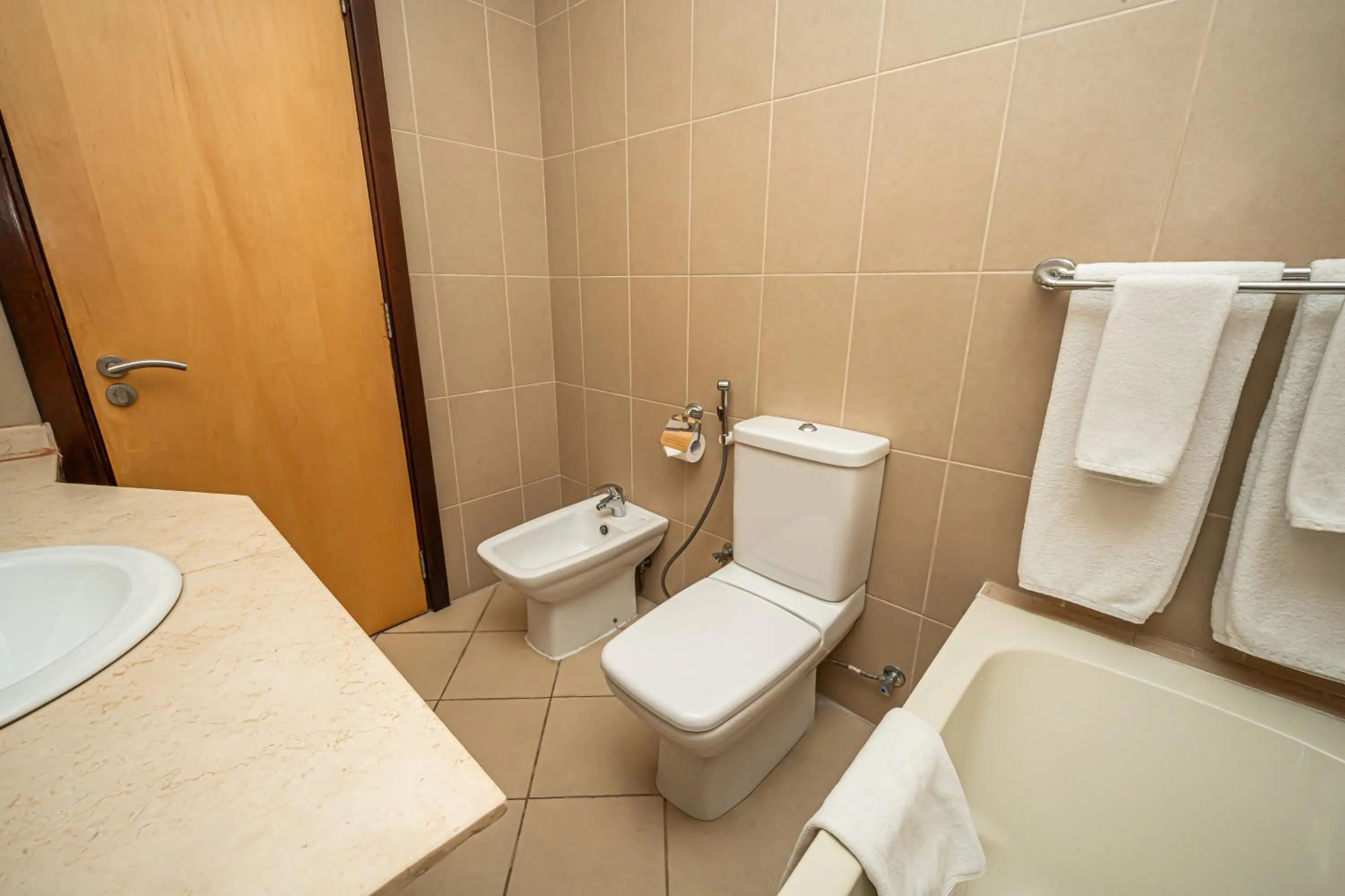 Toilet in Kingsgate Hotel Doha by Millennium Hotels