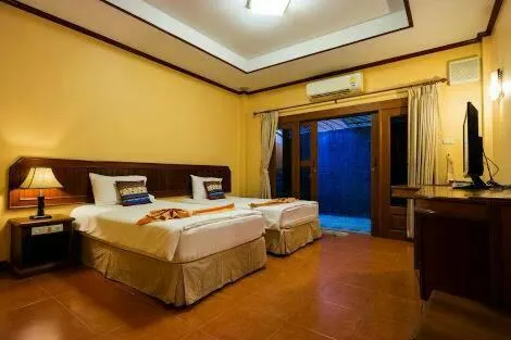 Bed in Baan Kiang Chan Resort