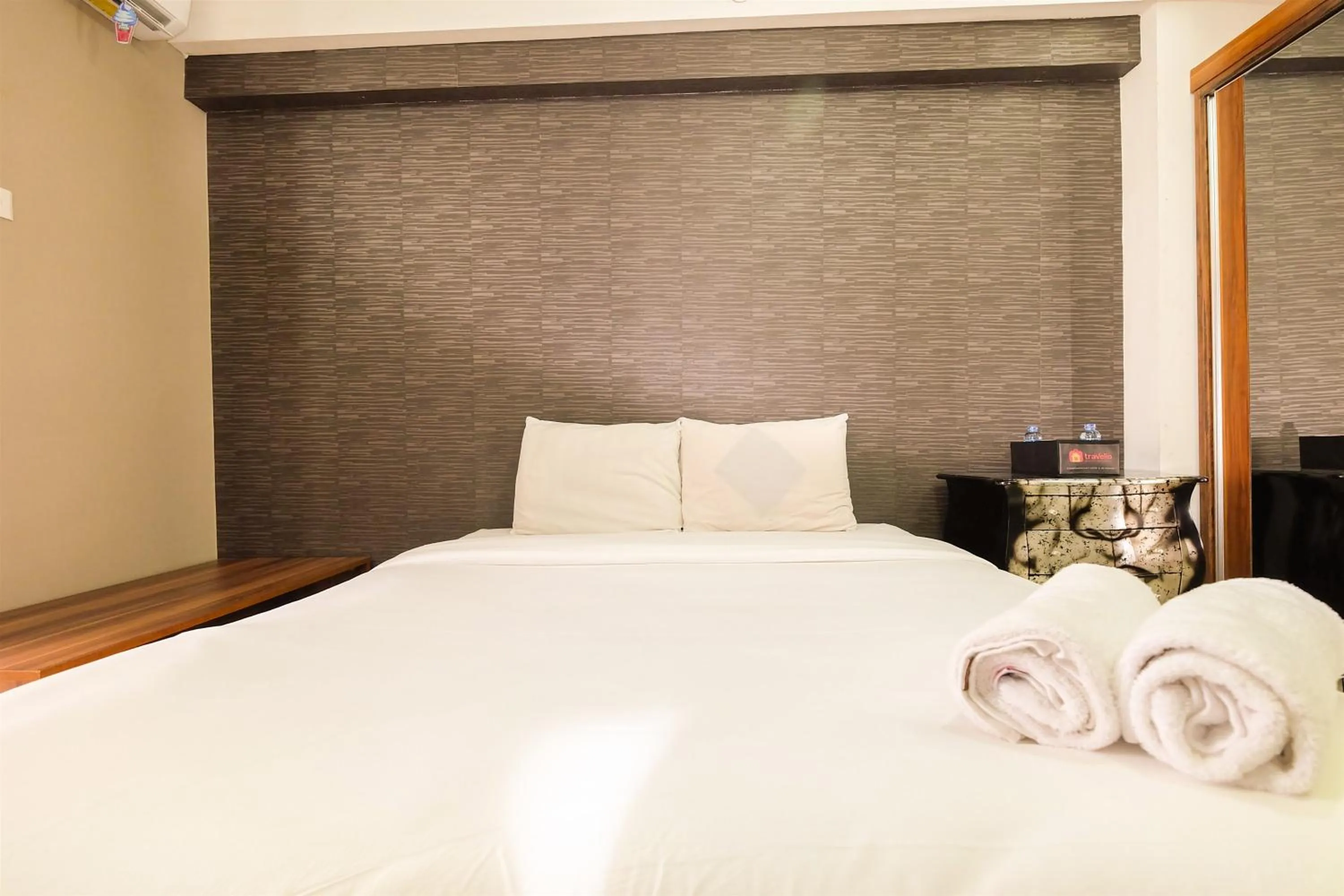 Bed in Simple Studio Bassura City Apartment By Travelio
