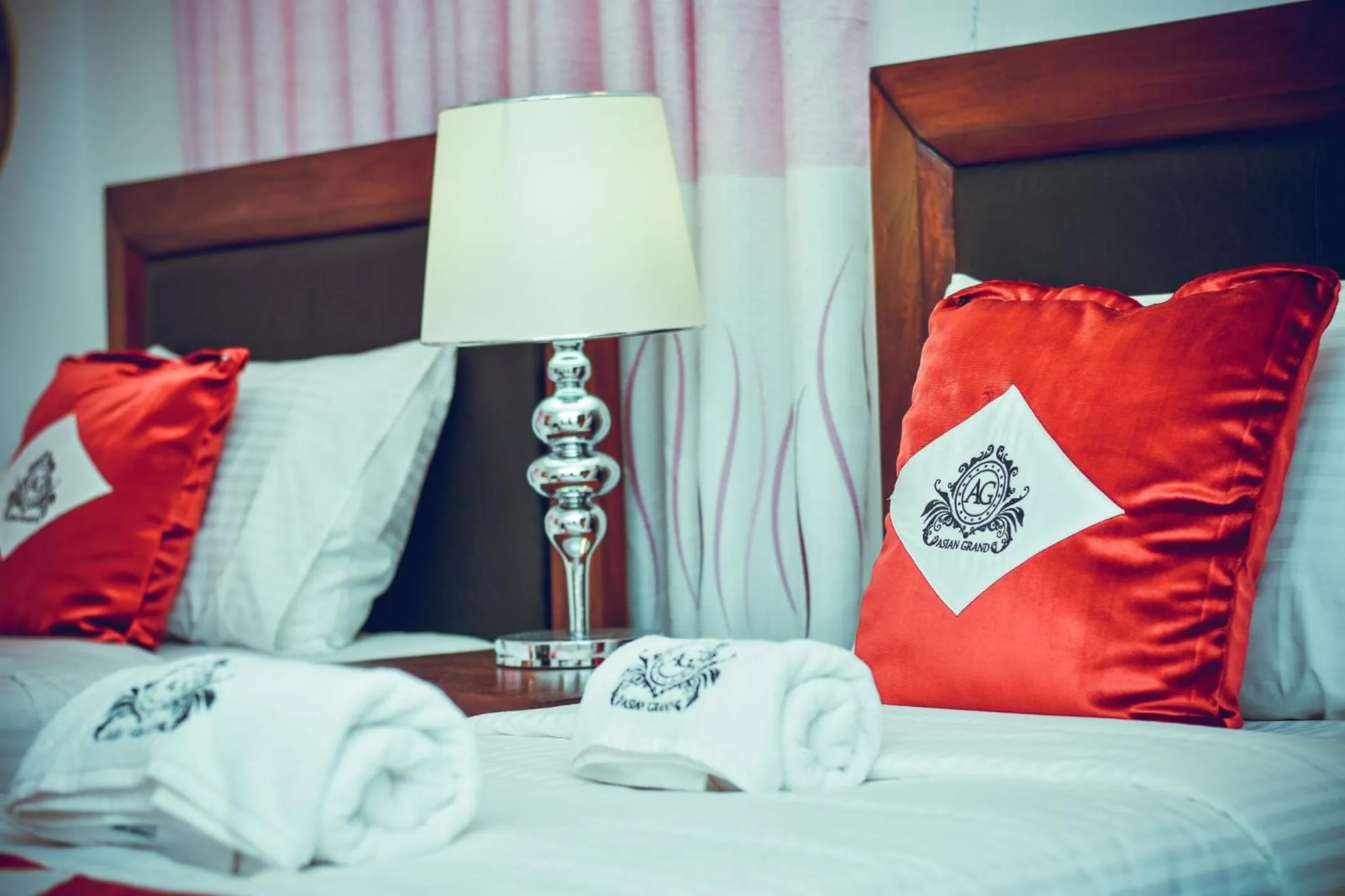 Bed in Asian Grand Hotel