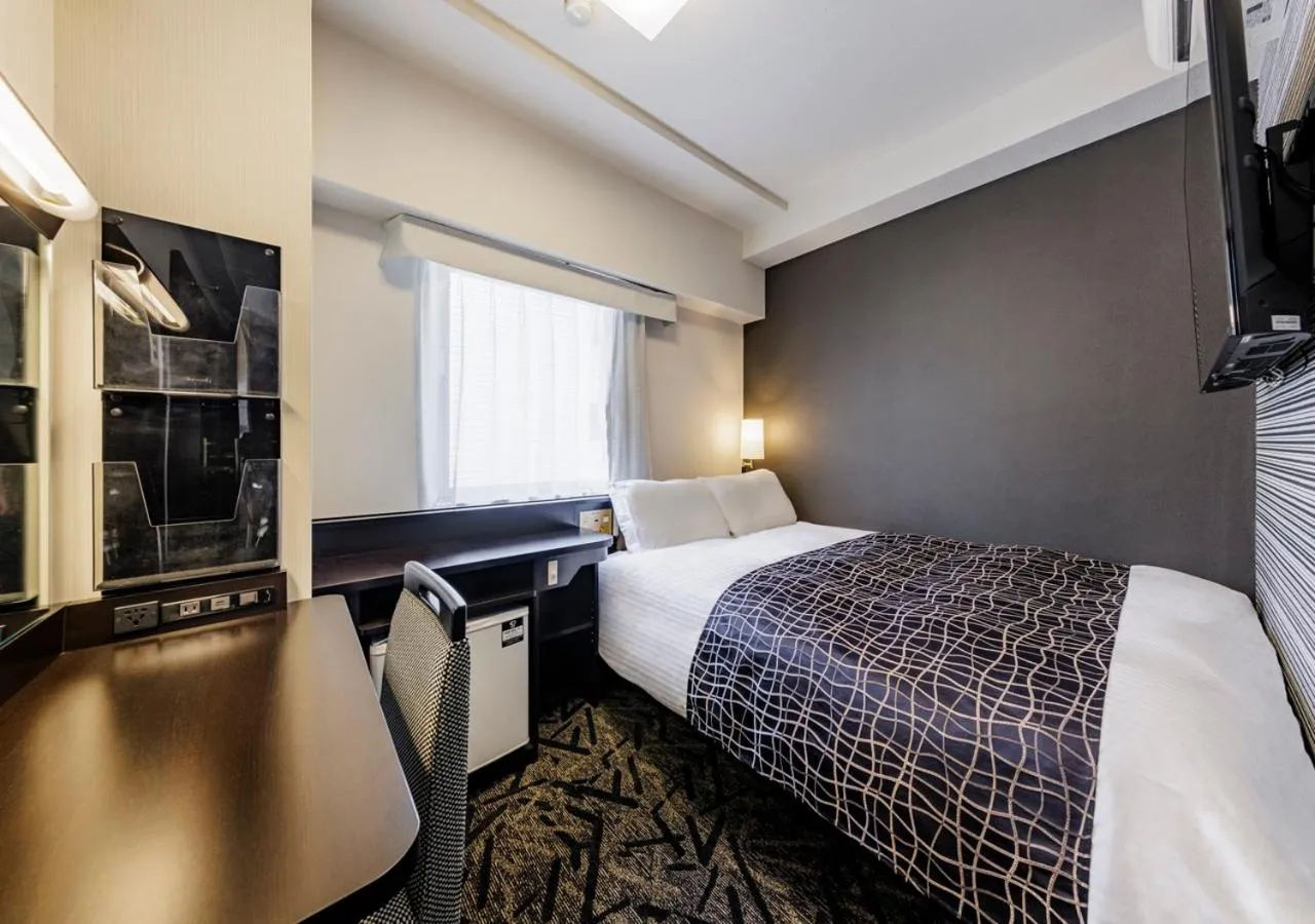 Bed in APA Hotel Hakata Ekimae 4 chome