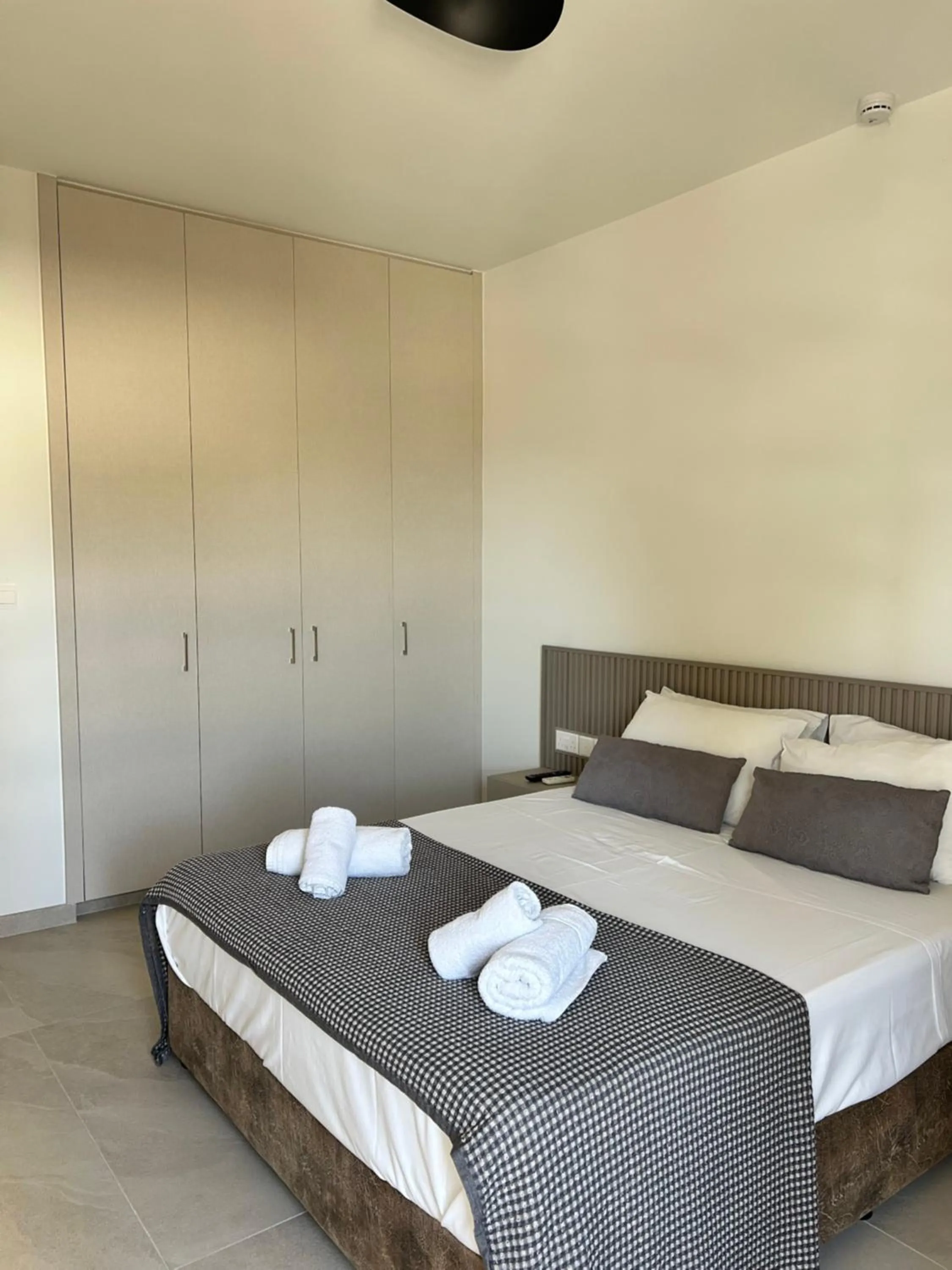 Bed in Pigeon Beach Hotel Apartments