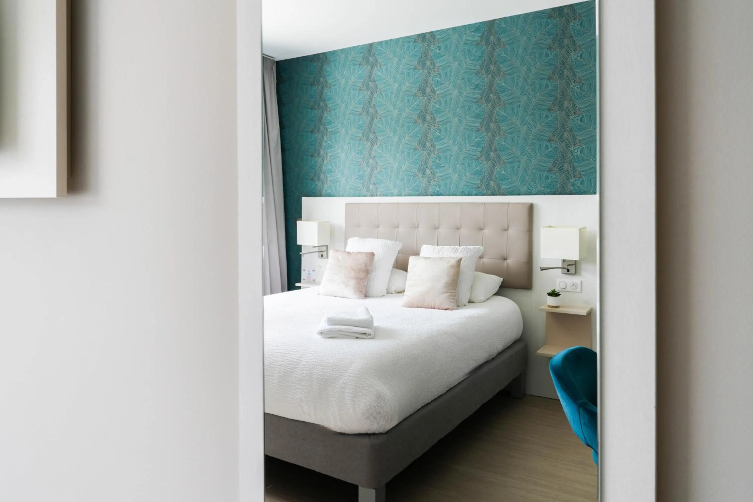 Bed in Logis Hôtel l'Amandier