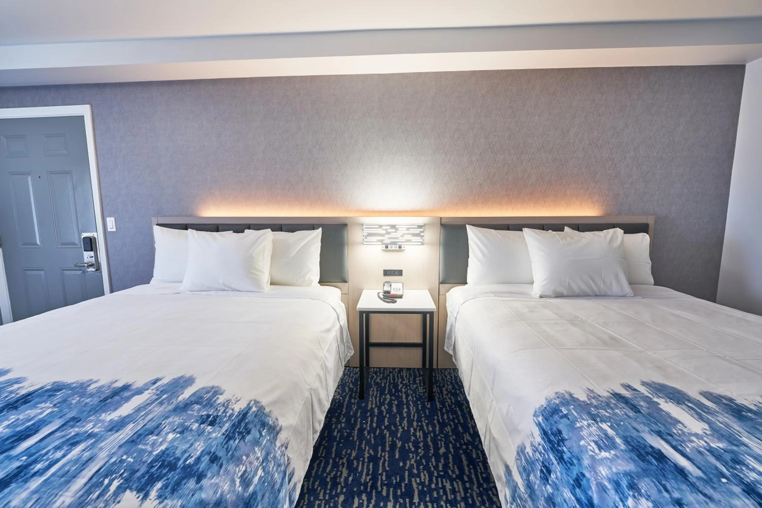 Bed in All Seasons Inn & Suites