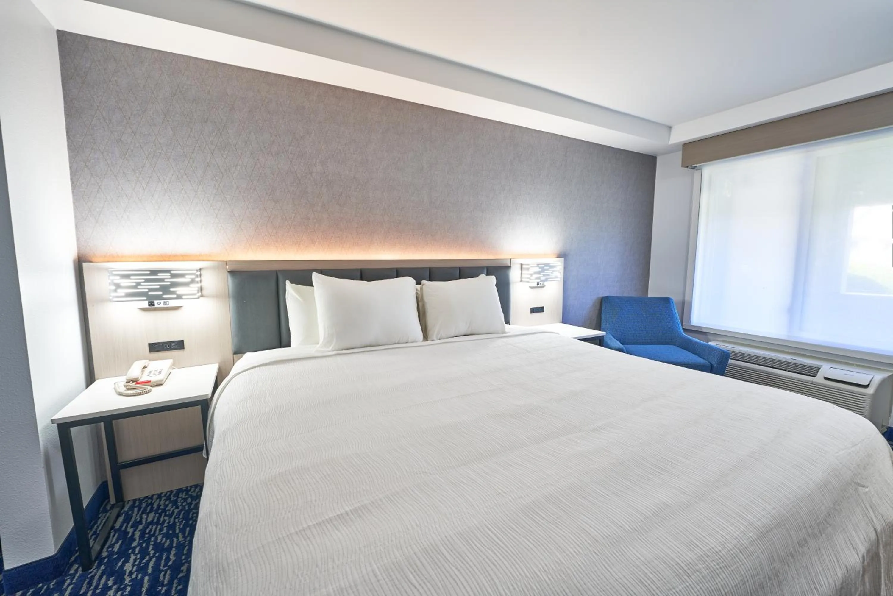 Bed in All Seasons Inn & Suites