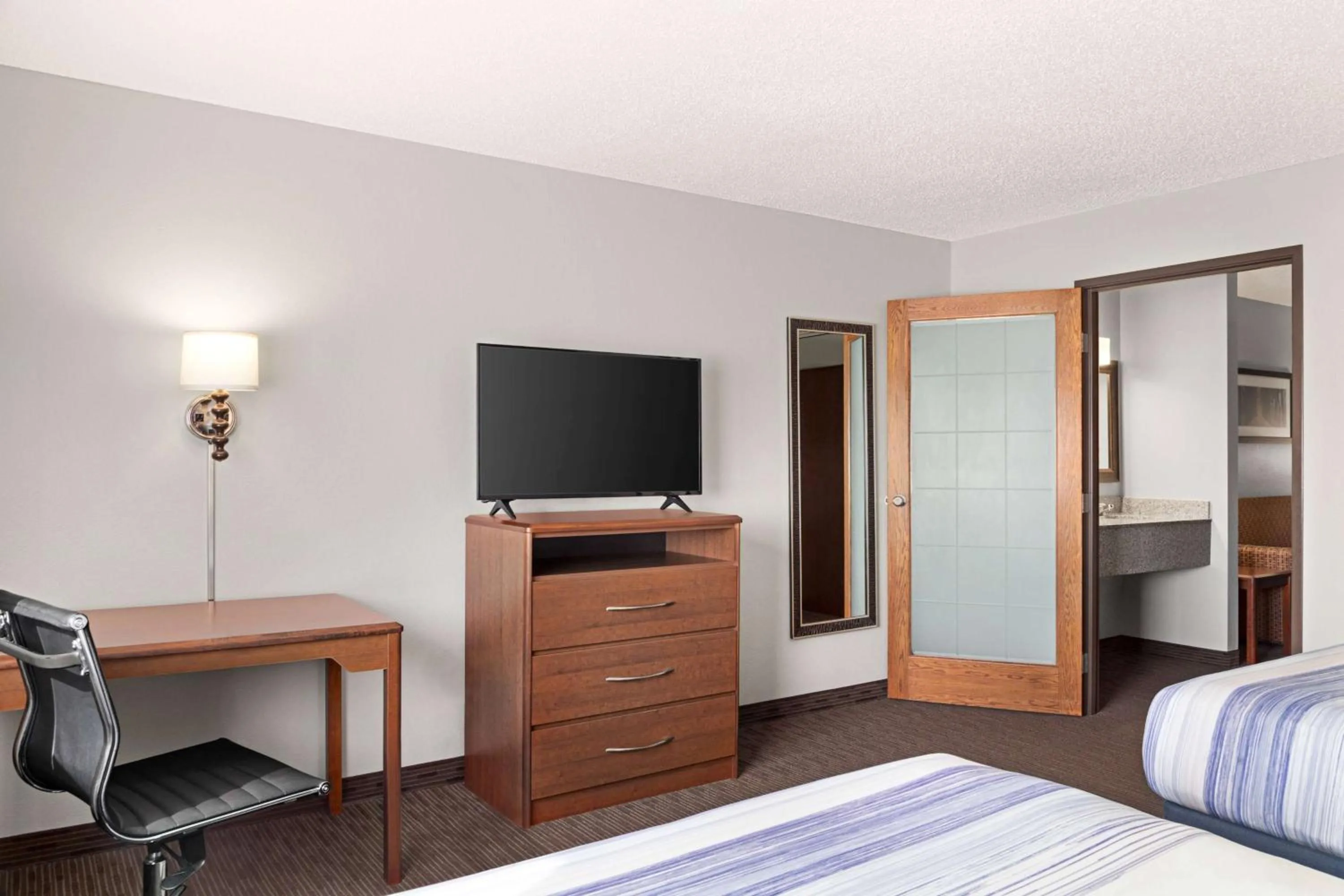 Bed in AmericInn by Wyndham Sauk Centre