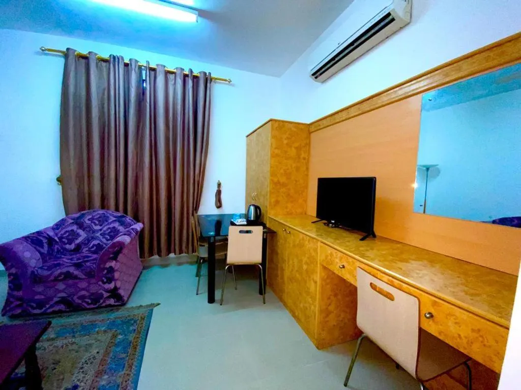 Communal lounge/ TV room in Savoy Inn Hotel Apartments