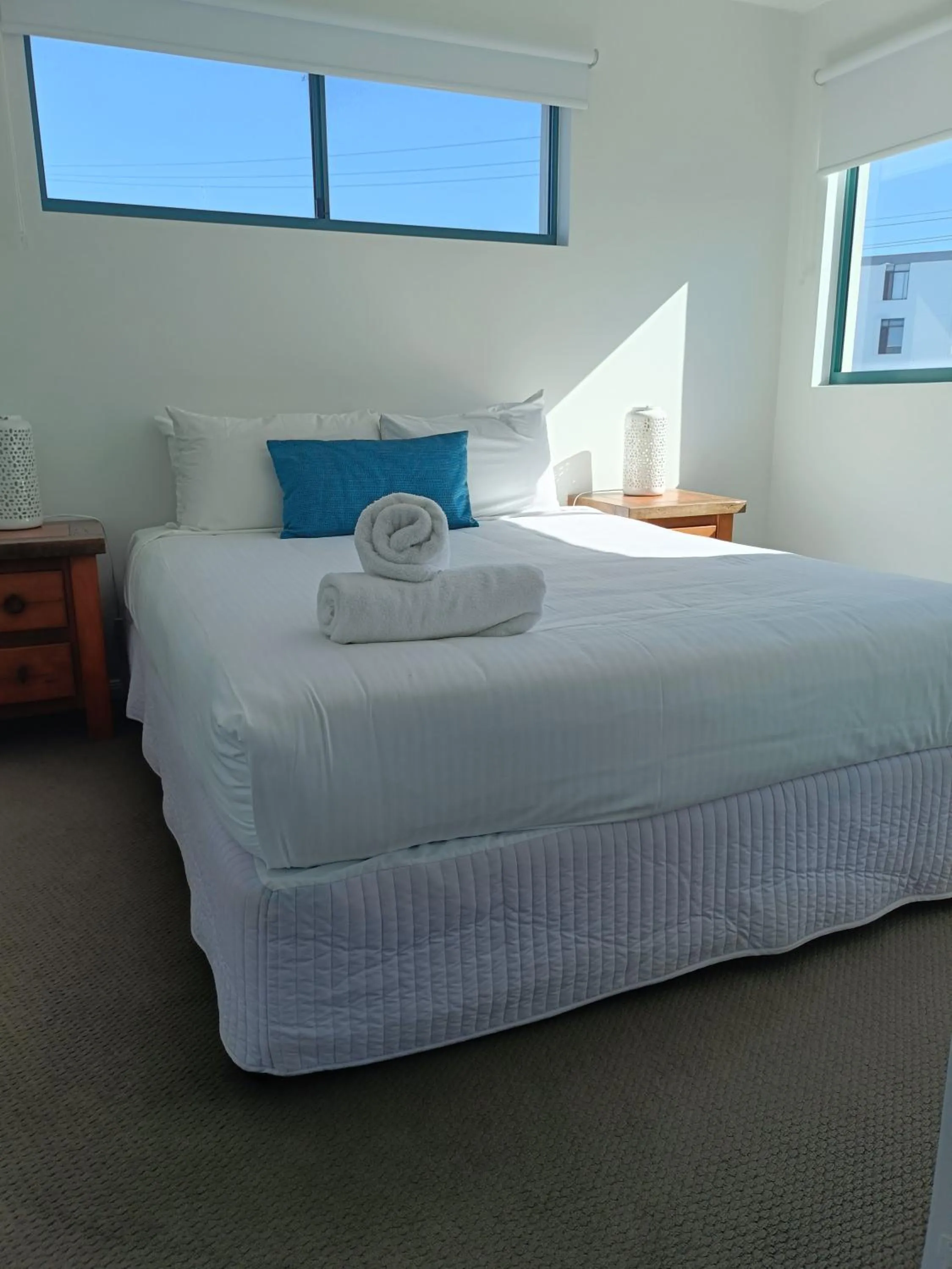 Bed in Grand Palais Boolarong Beachside Apartments