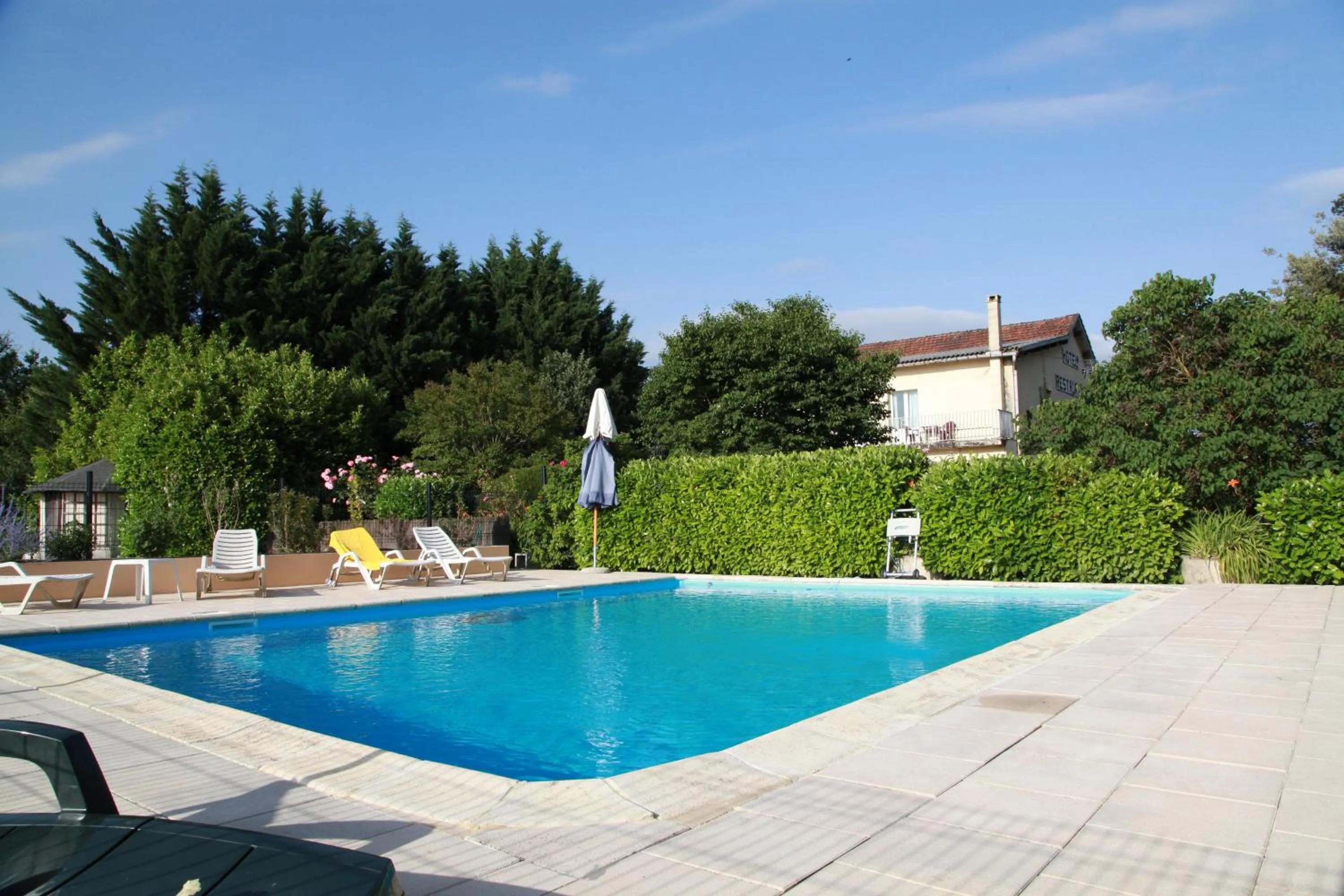 Swimming pool in Logis Hôtel Restaurant La Borie