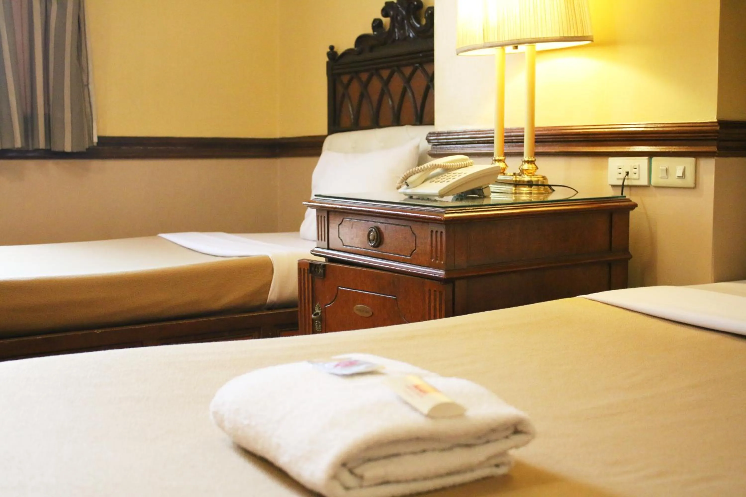 Bed in Camelot Hotel Quezon City powered by Cocotel