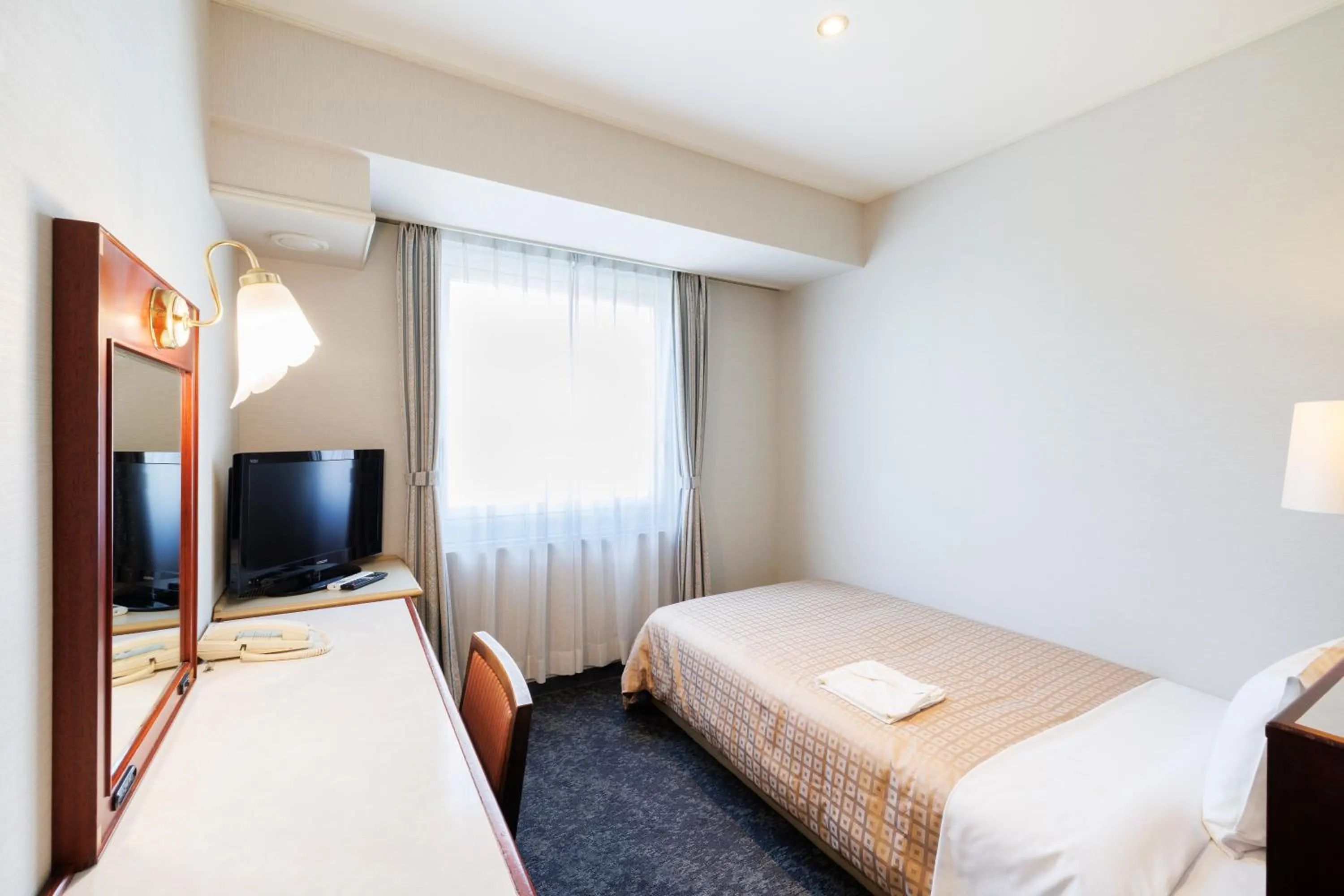 Bed in Hiroshima Intelligent Hotel Annex