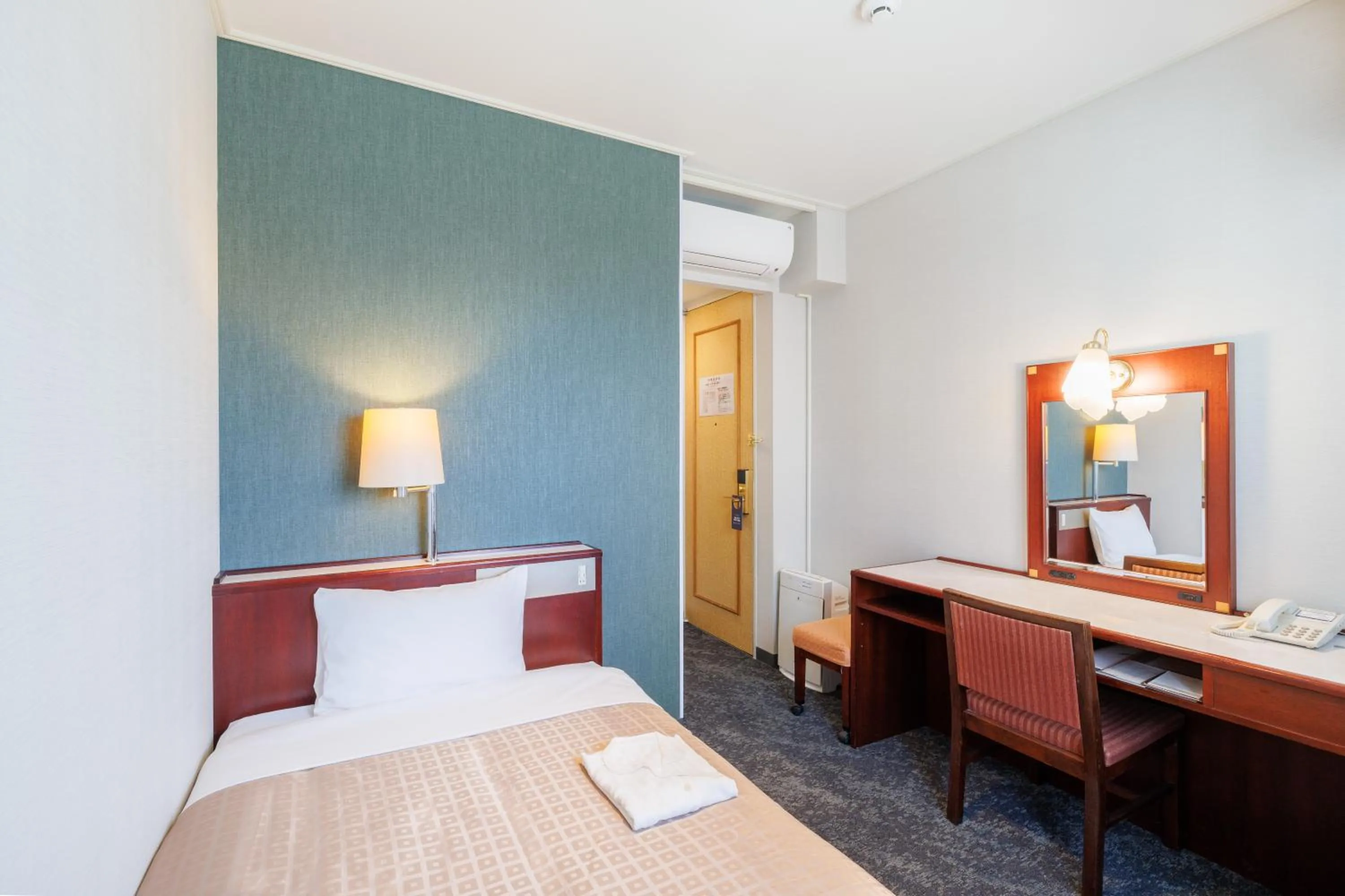 Bed in Hiroshima Intelligent Hotel Annex