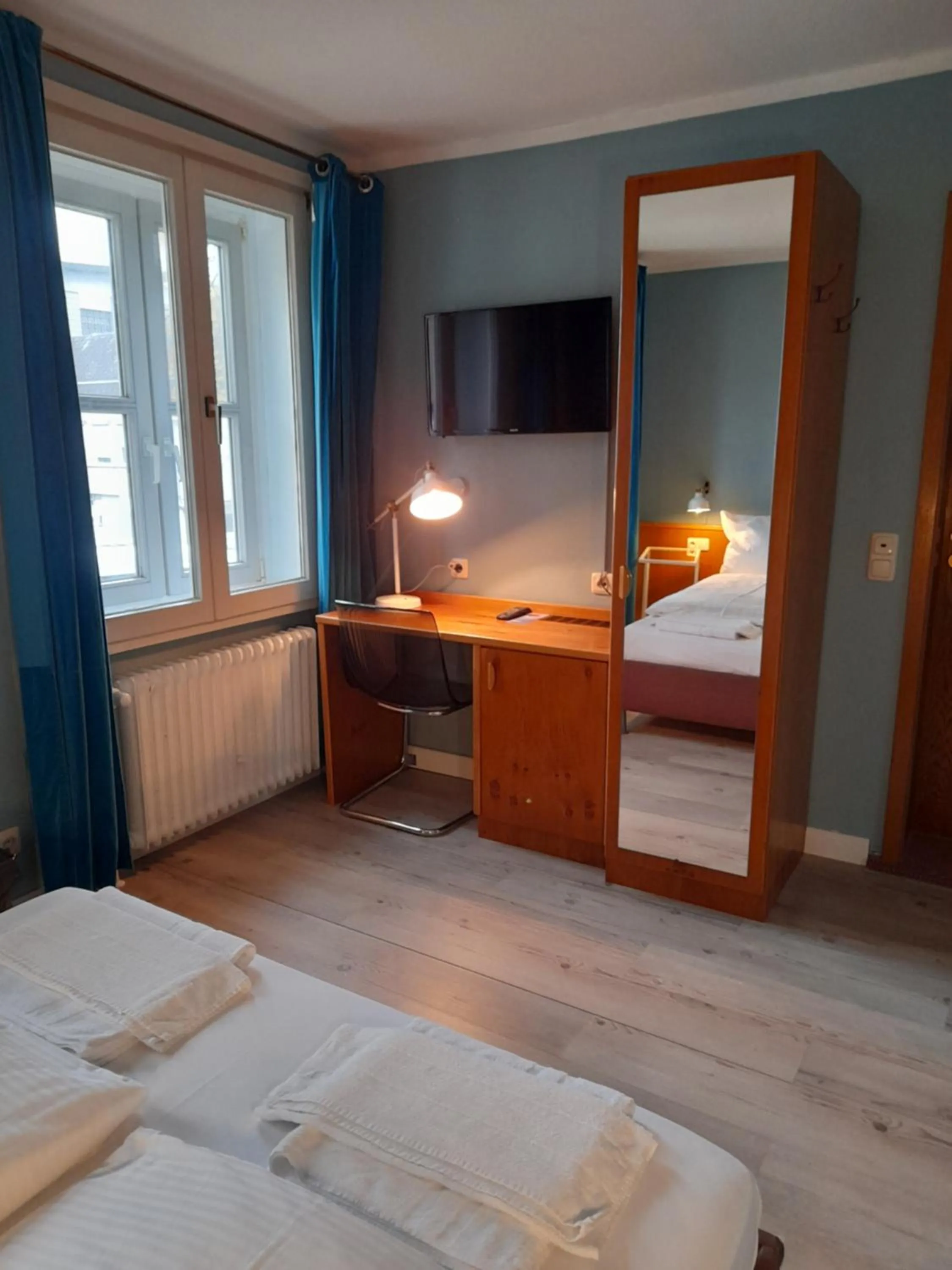 Seating area, Bed in Hotel Pelli Hof Rendsburg by Tulip Inn