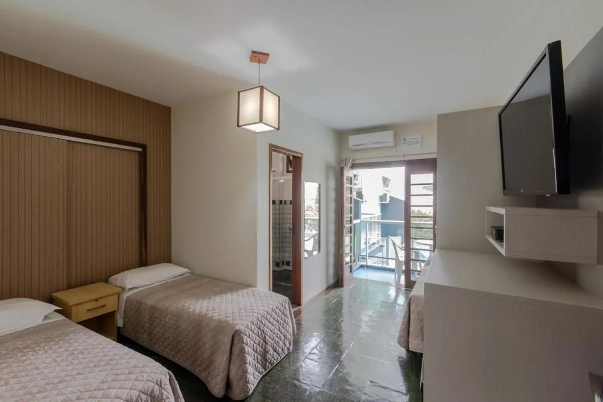 Photo of the whole room, Bed in Pousada Cores do Mar | Conforto com Piscina em Bombinhas