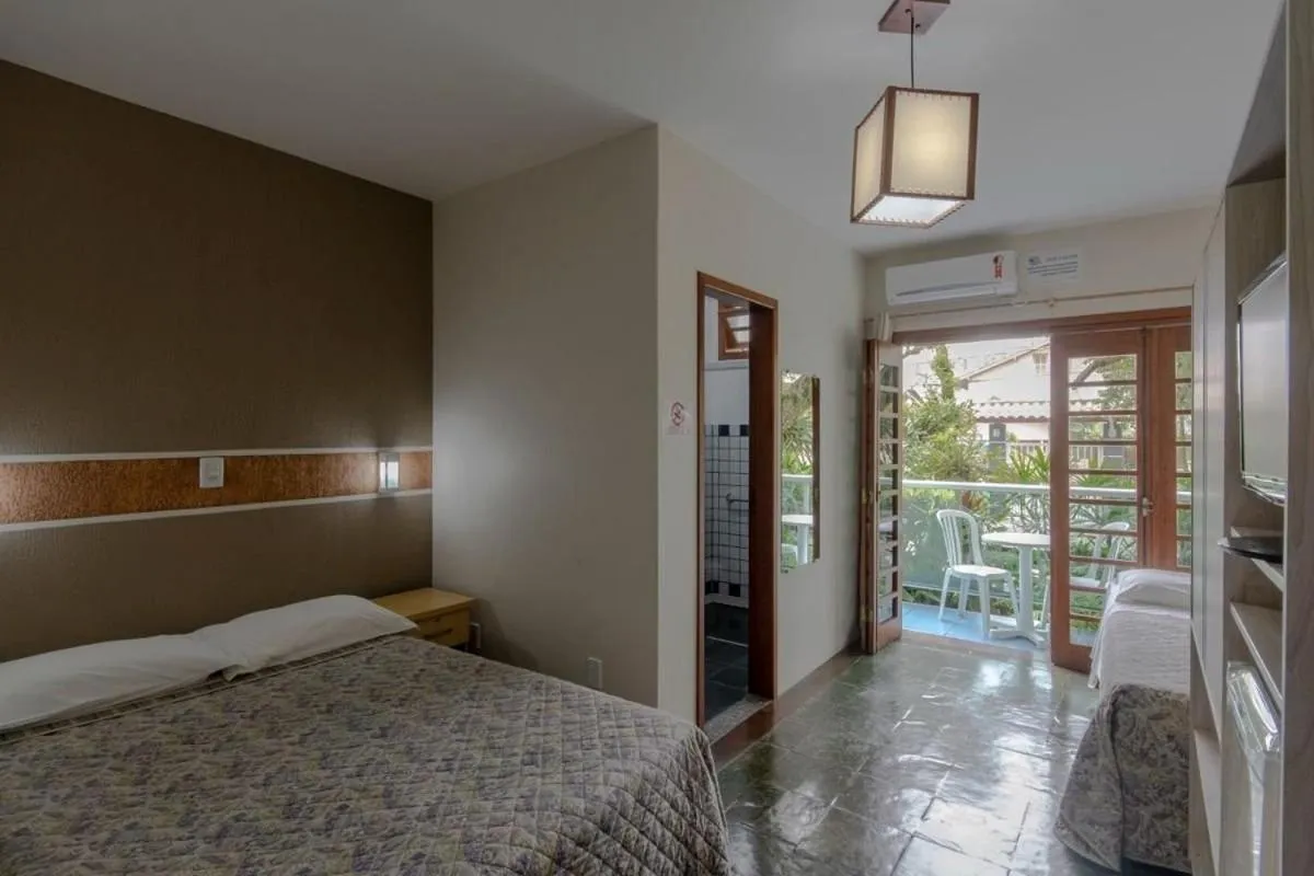 Photo of the whole room, Bed in Pousada Cores do Mar | Conforto com Piscina em Bombinhas