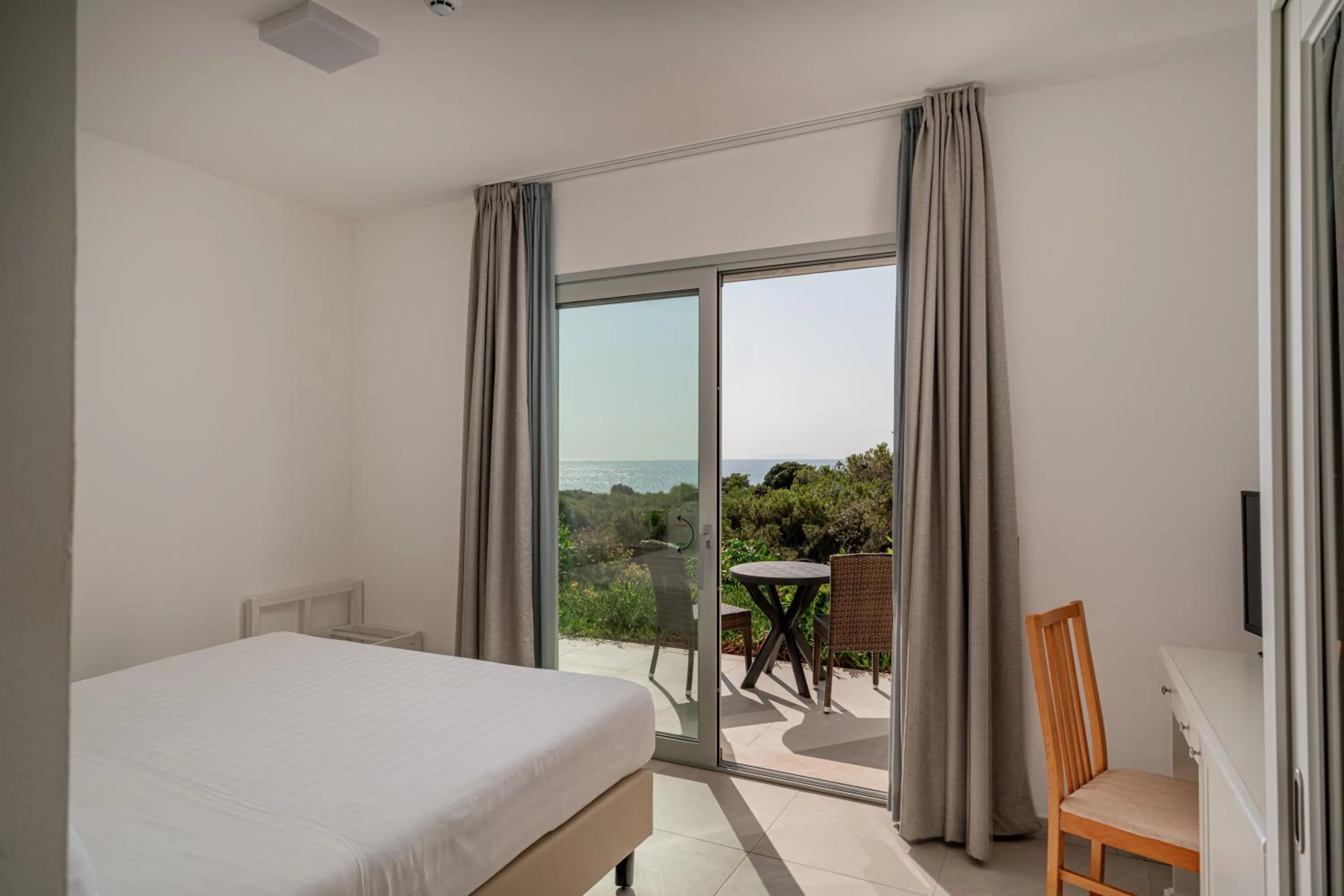 Bedroom, Bed in Bellevue Sardinia Resort Affiliated by Meliá