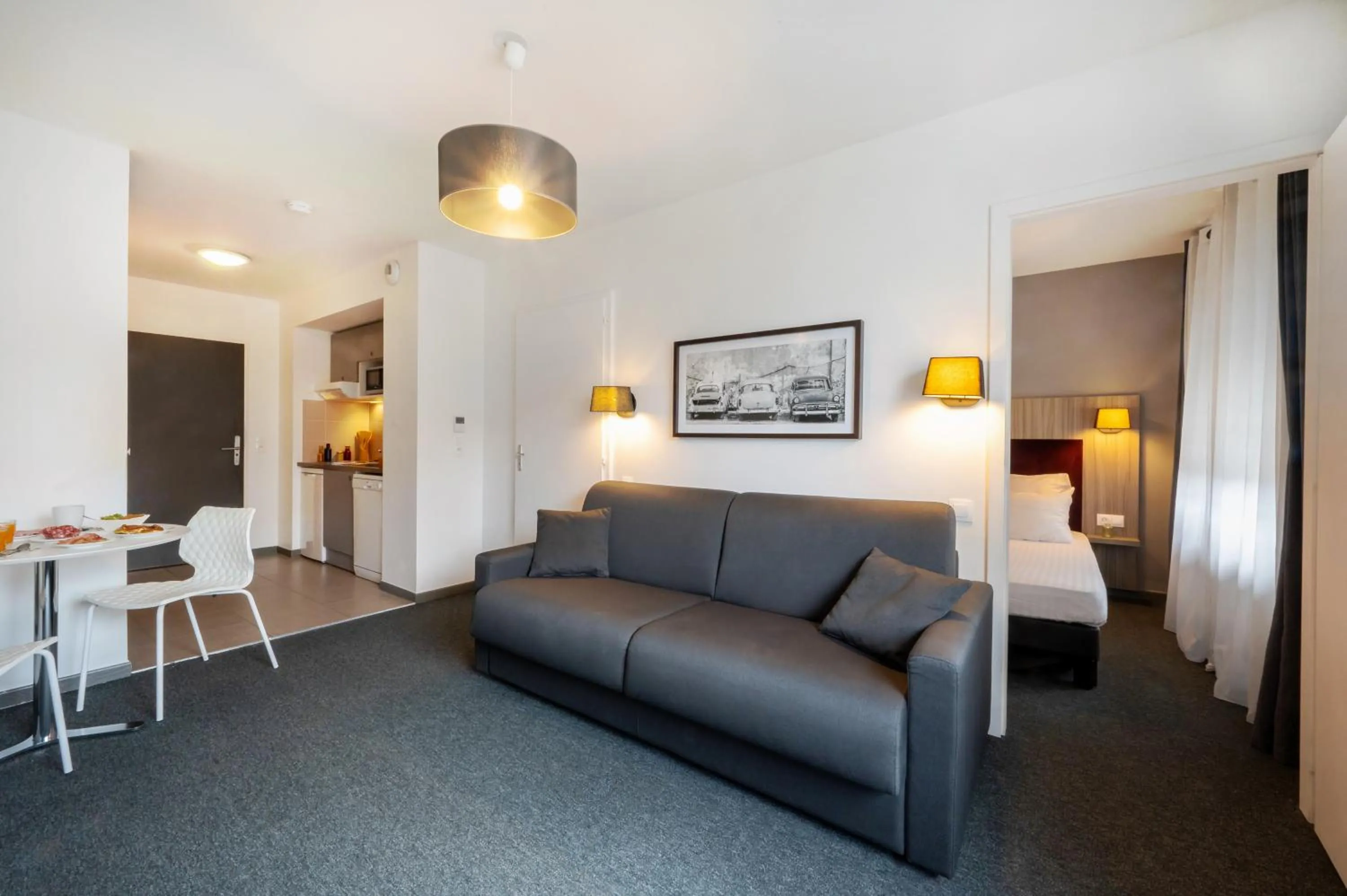 Living room, Bed in Nemea Appart Hotel Elypseo Strasbourg Port