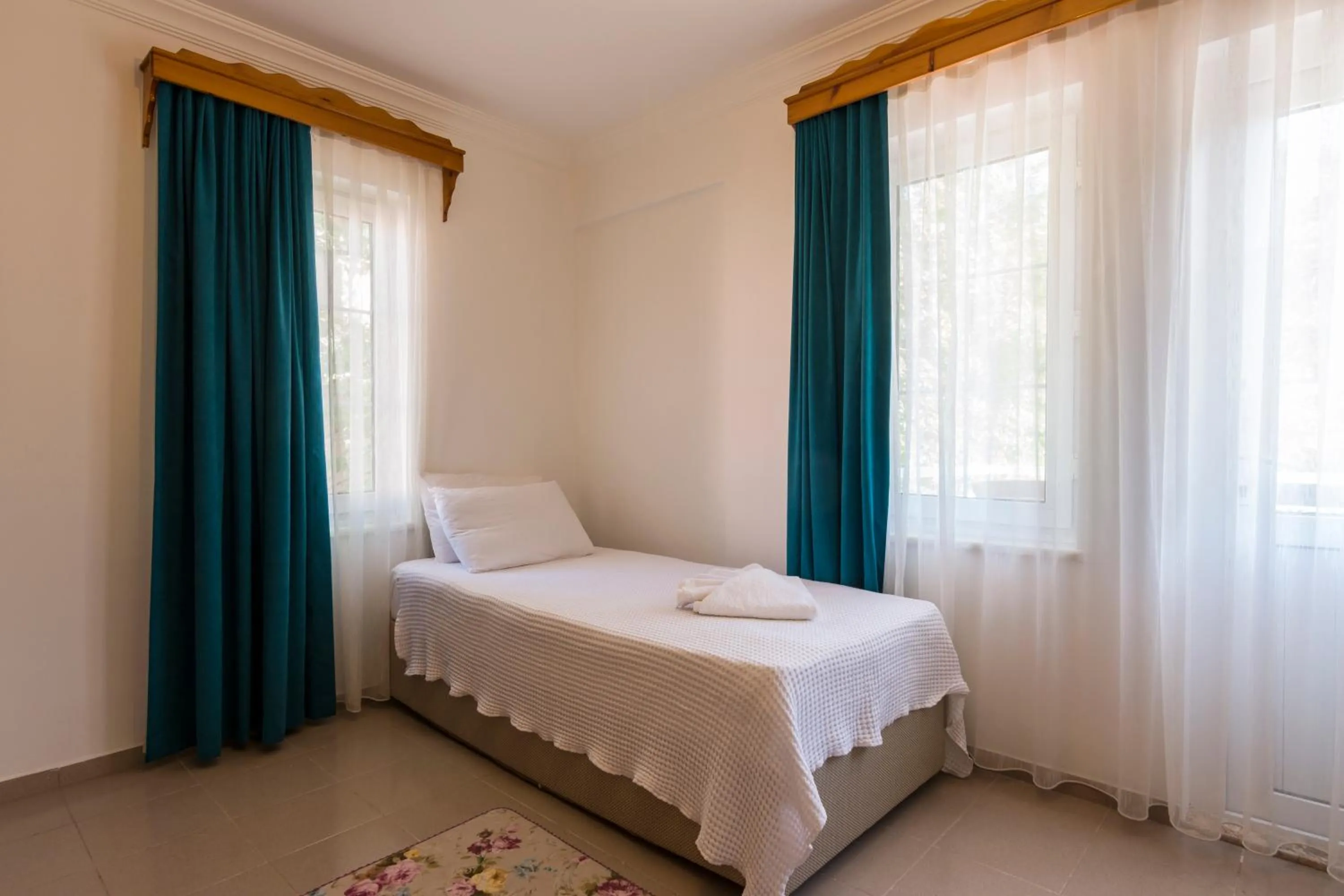 Bed in Calypso Cozy Suites