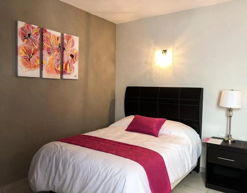 Bed in Hotel Bugambilias Rooms