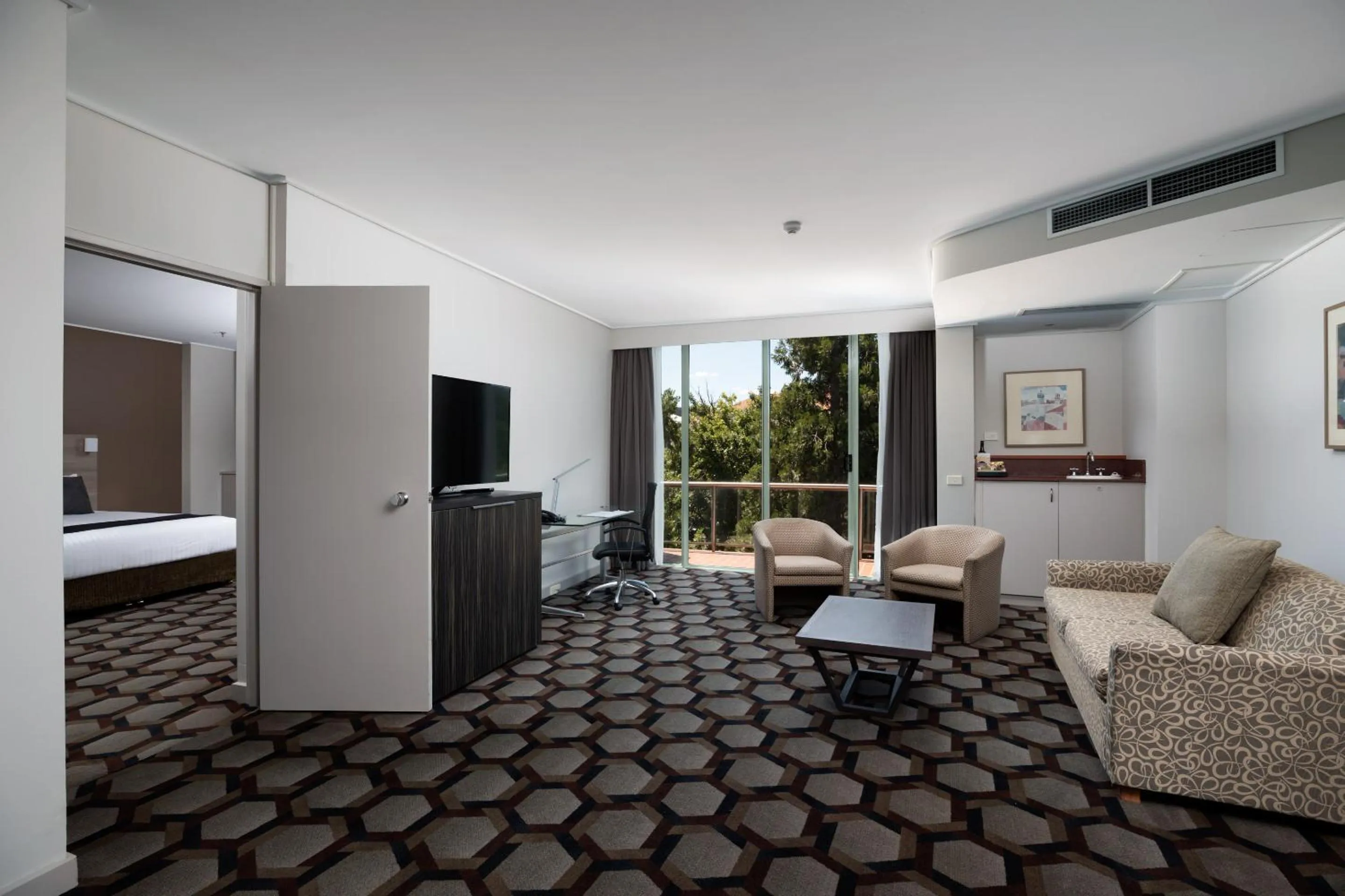 Living room, Bed in Rydges Canberra