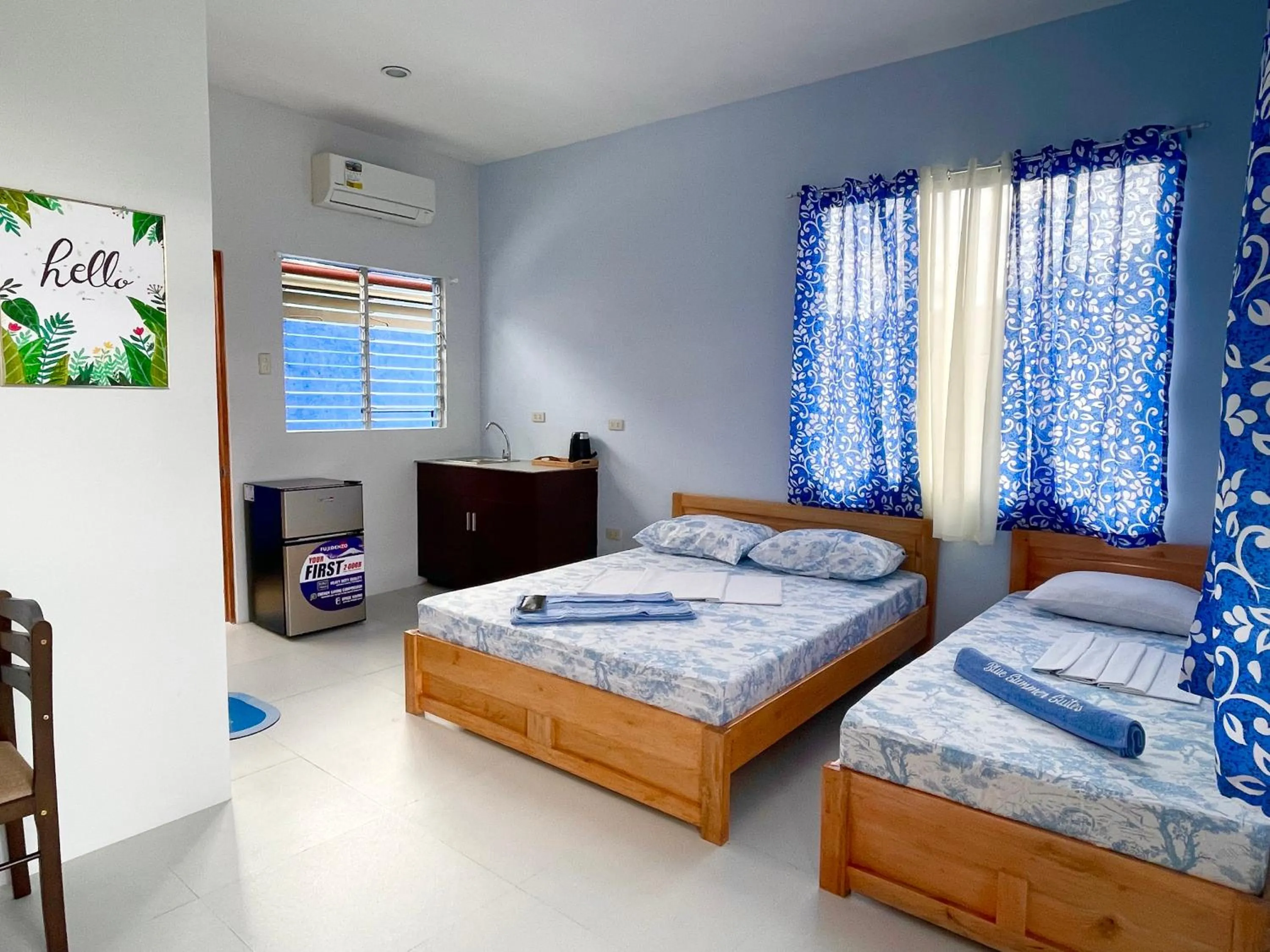 Bed in Blue Summer Suites & Restaurant