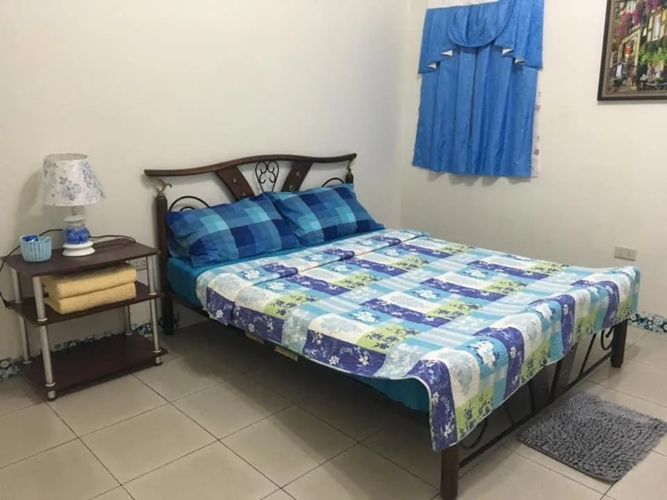 Bed in Blue Summer Suites & Restaurant