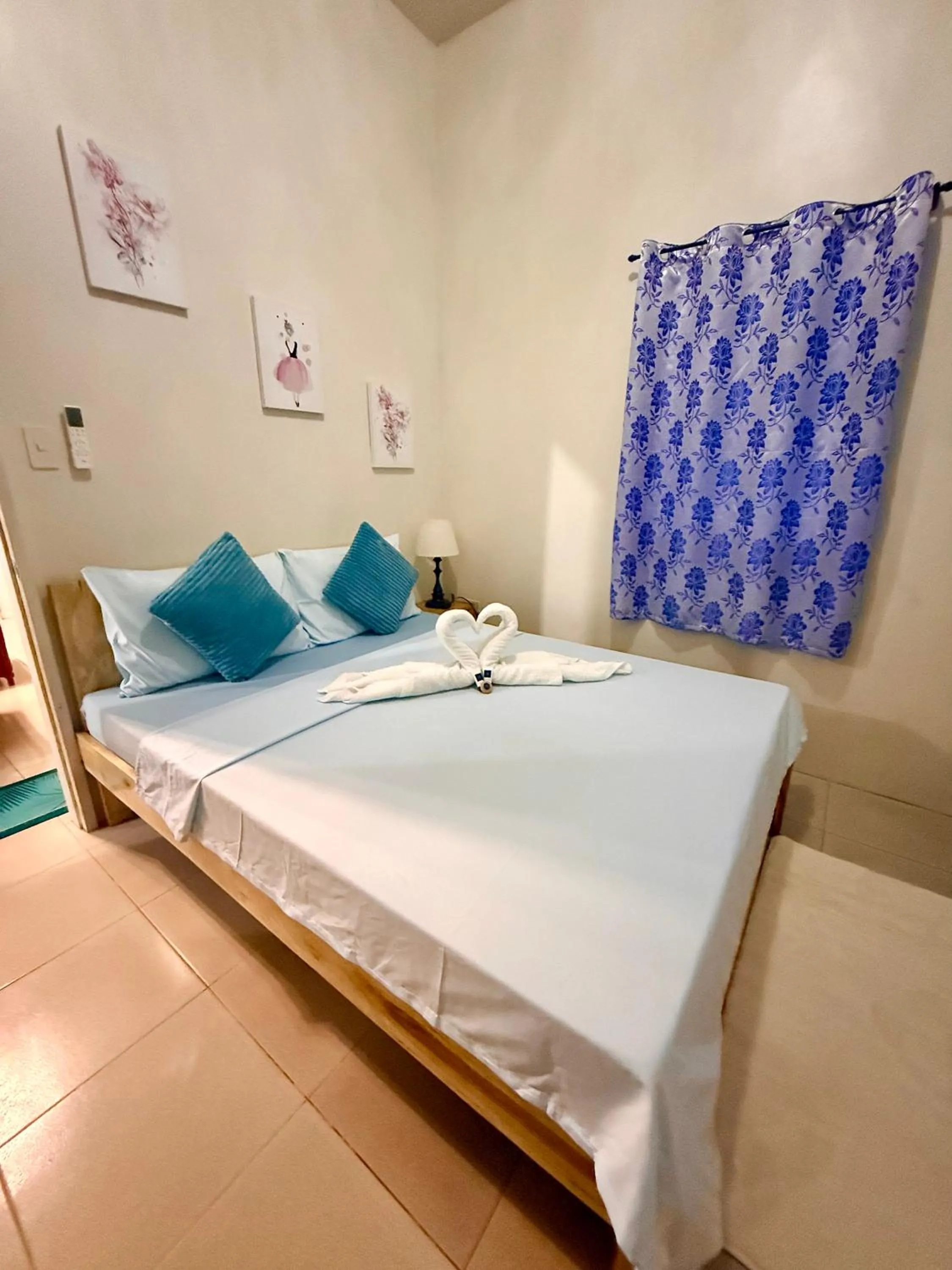 Bed in Blue Summer Suites & Restaurant