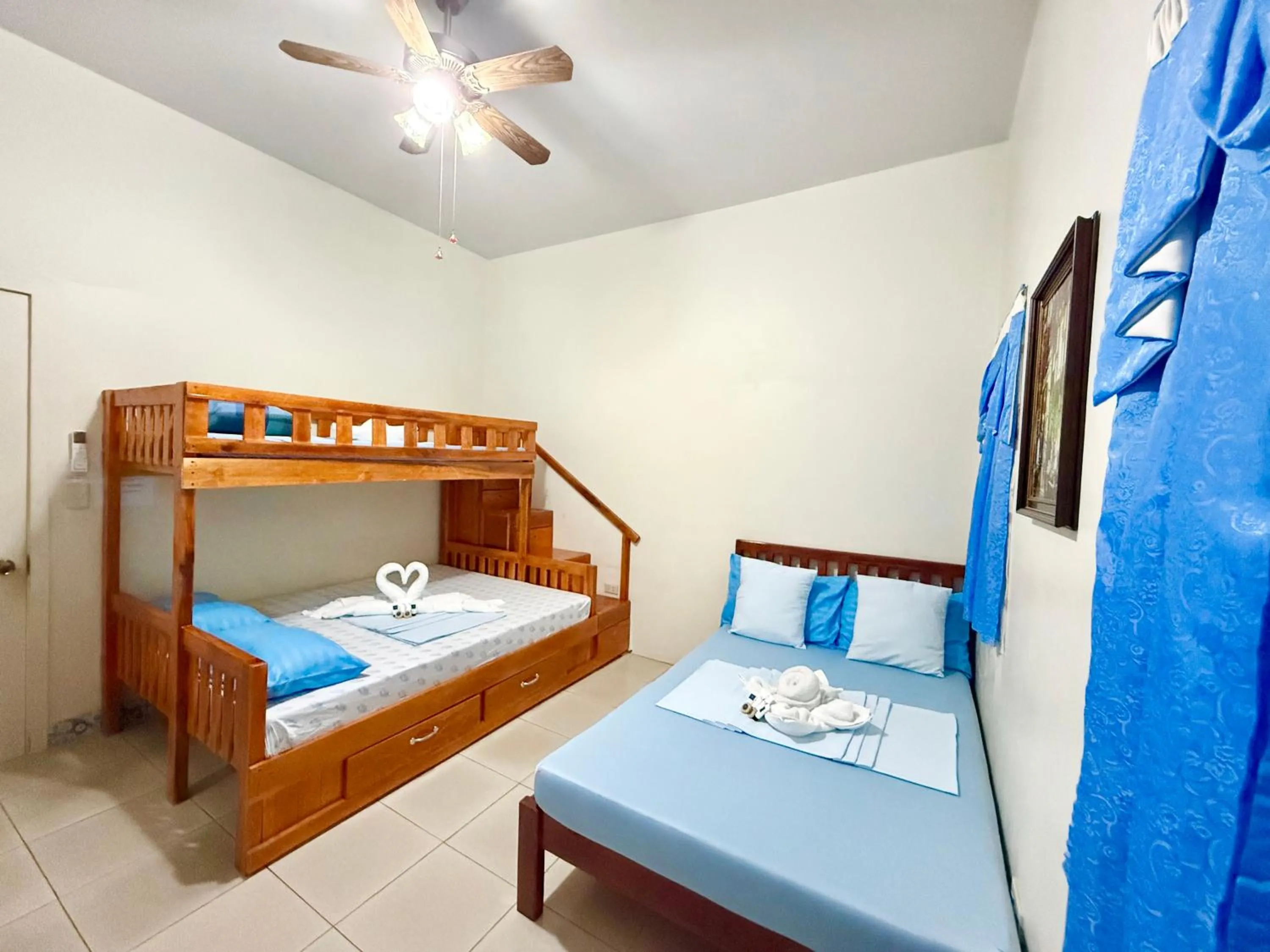 Bed in Blue Summer Suites & Restaurant